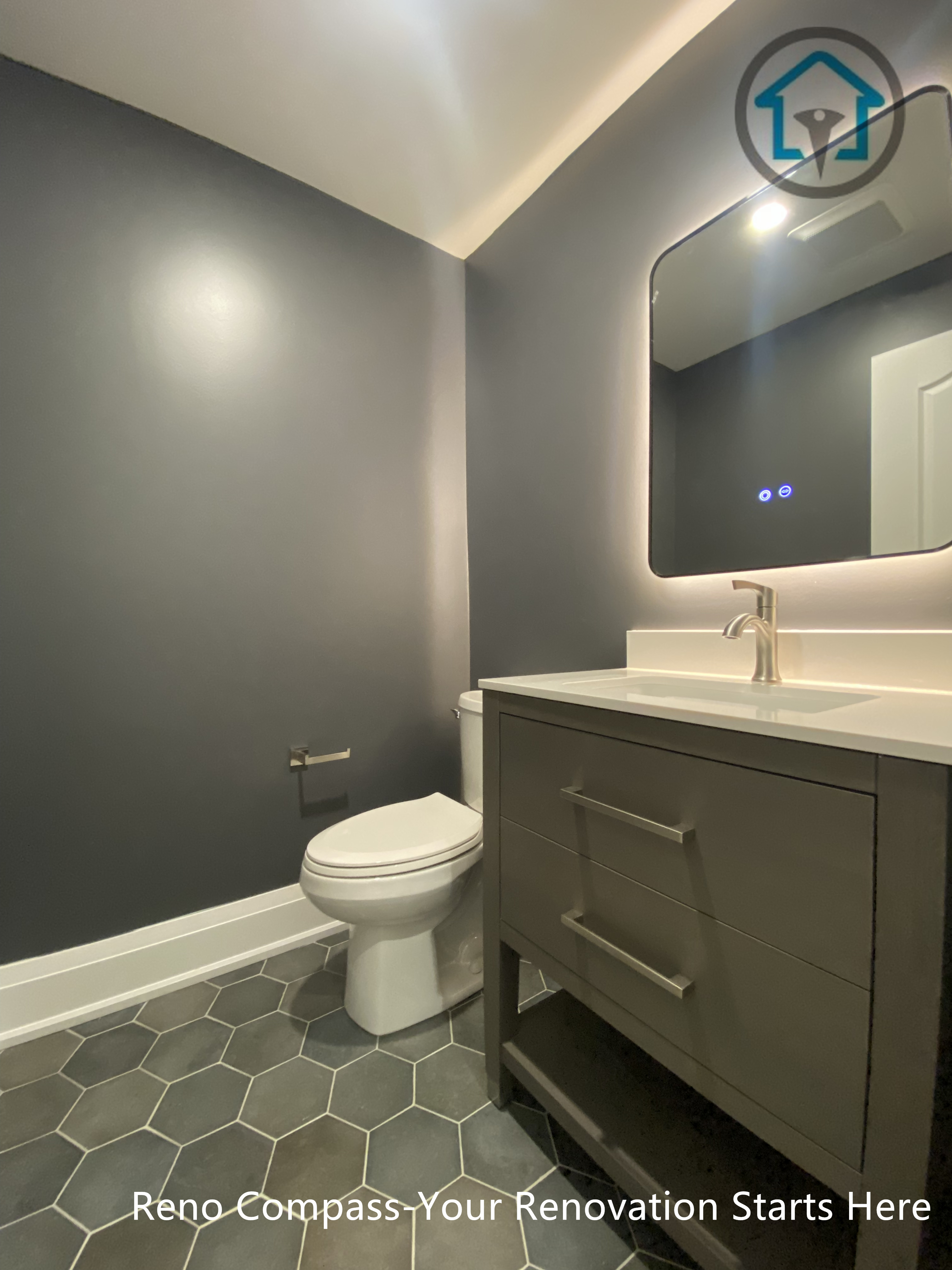 This Richmond Hill bathroom renovation features a modern powder room design with a compact vanity, backlit mirror, and dark wall finishes. The layout maximizes functionality in a small space while maintaining a clean, contemporary look, completed by a trusted Toronto renovation company.