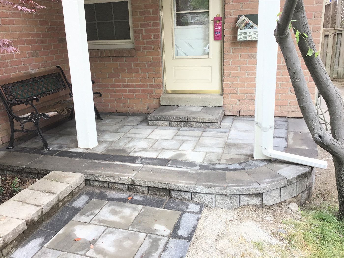 This Oakville interlocking project features a beautifully curved walkway integrated with a raised garden bed and natural stone borders. The soft curve design enhances the landscape flow while maintaining a clean and structured layout. Built with durable grey pavers, this installation improves accessibility, drainage, and curb appeal, creating a harmonious blend between hardscape and greenery.