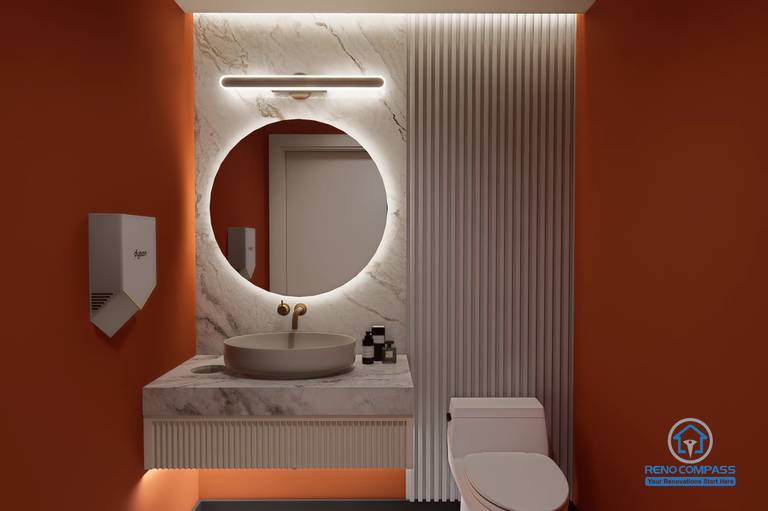 A modern washroom design in a Markham medical aesthetic clinic renovation project, featuring Hermès orange accents, marble finishes, and soft lighting to enhance client comfort and overall experience.