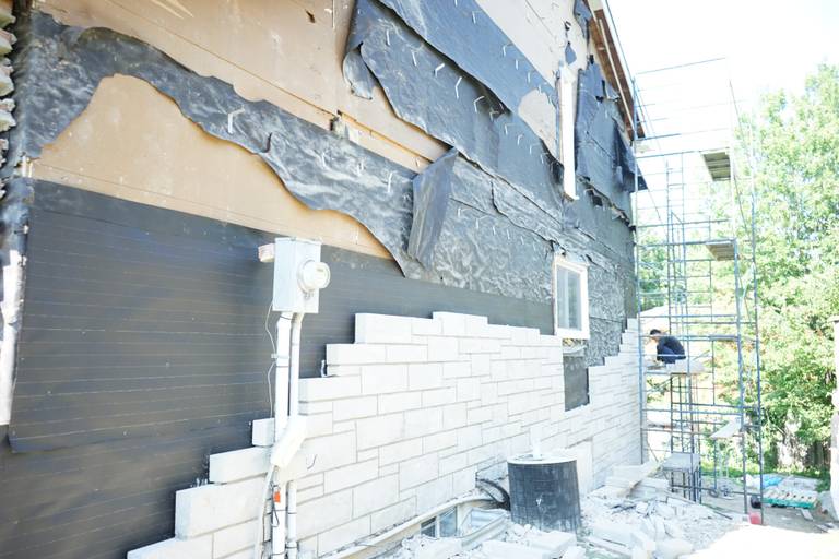Professional exterior wall remodeling project in Richmond Hill showcasing a refreshed brick façade using high-quality finishes.