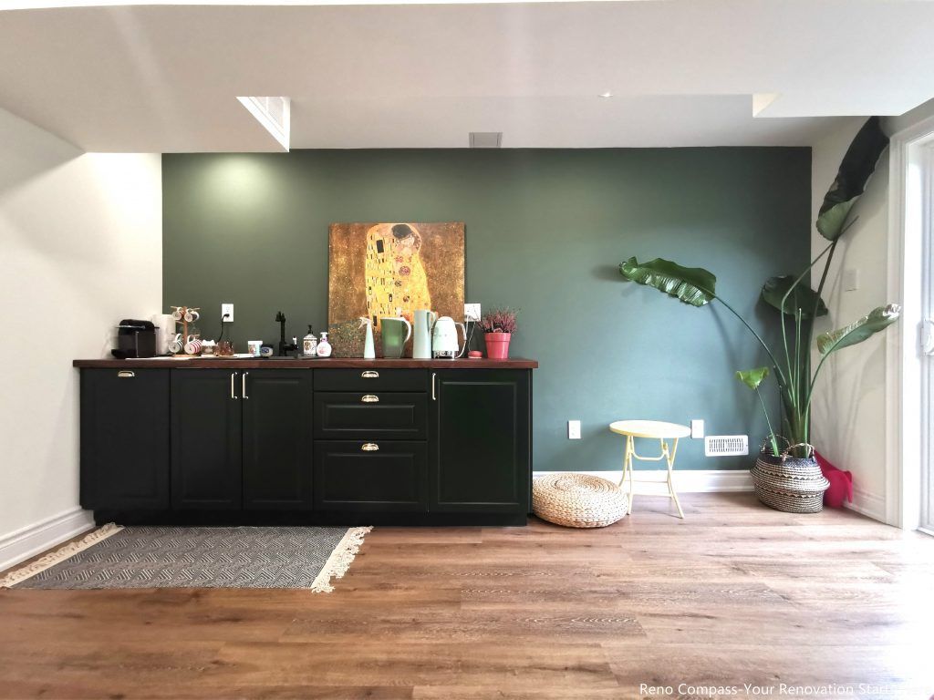 This image showcases a completed basement renovation in Vaughan, featuring a custom built-in cabinet system paired with a bold accent wall that adds depth and character to the space. The upgraded wood flooring enhances warmth and durability, making the basement suitable for everyday living, entertaining, or relaxation. Thoughtful lighting placement and clean wall finishes help create a balanced and inviting atmosphere, while the open layout allows flexible use of the space. This basement renovation reflects the design sensibility and construction quality delivered by a professional Toronto renovation company focused on functional and livable interiors.