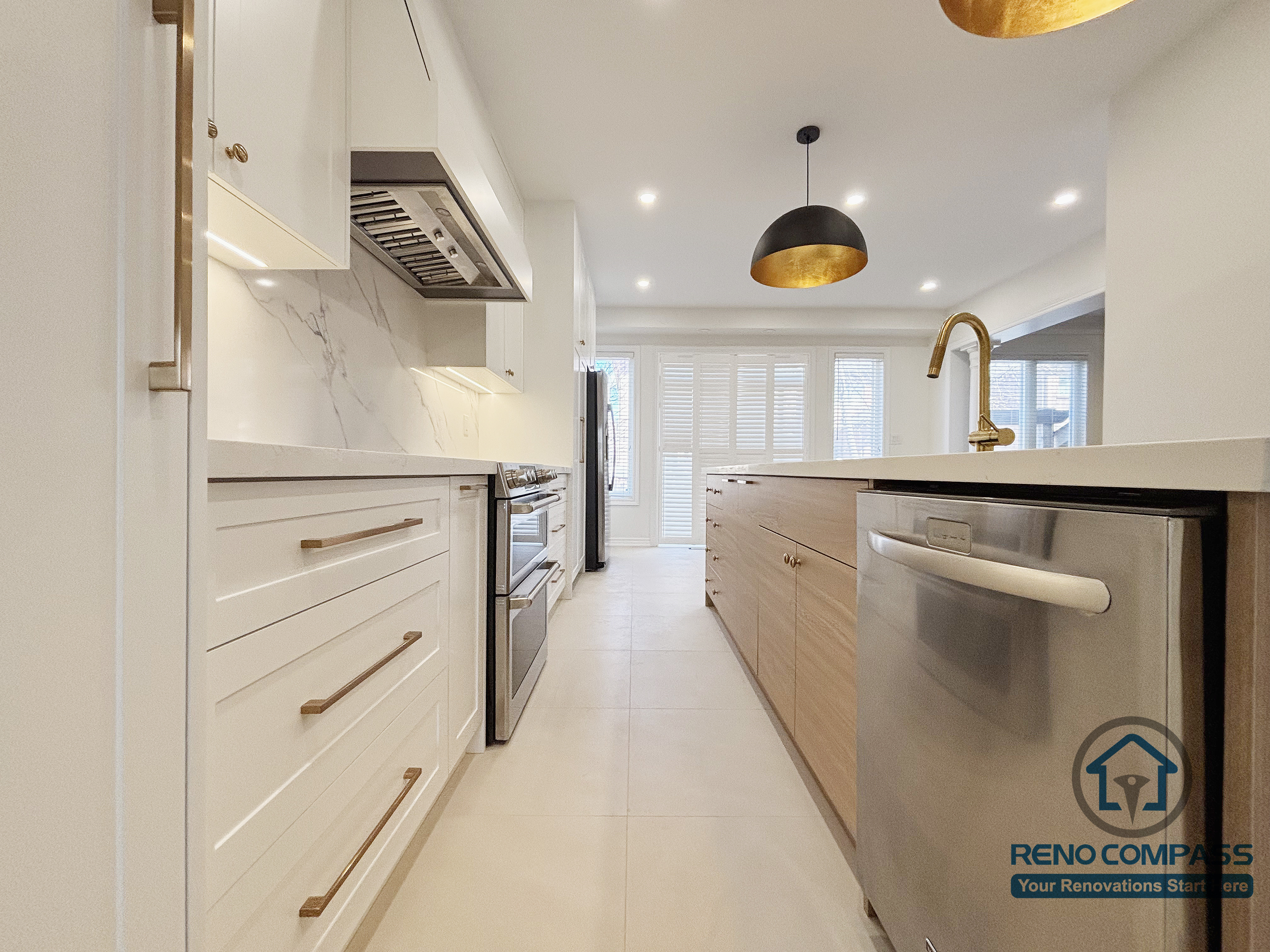 This Oakville kitchen renovation captures the primary cooking corridor, illustrating a galley-style workflow between the main cabinetry wall and the central island. The clear passage supports efficient movement between the stove, prep surfaces, and sink, while integrated appliances and consistent finishes maintain visual order. Thoughtful spacing and lighting enhance daily usability without overcrowding the space. Completed by Reno Compass, this kitchen design emphasizes practical circulation and long-term functionality in a modern Oakville home.