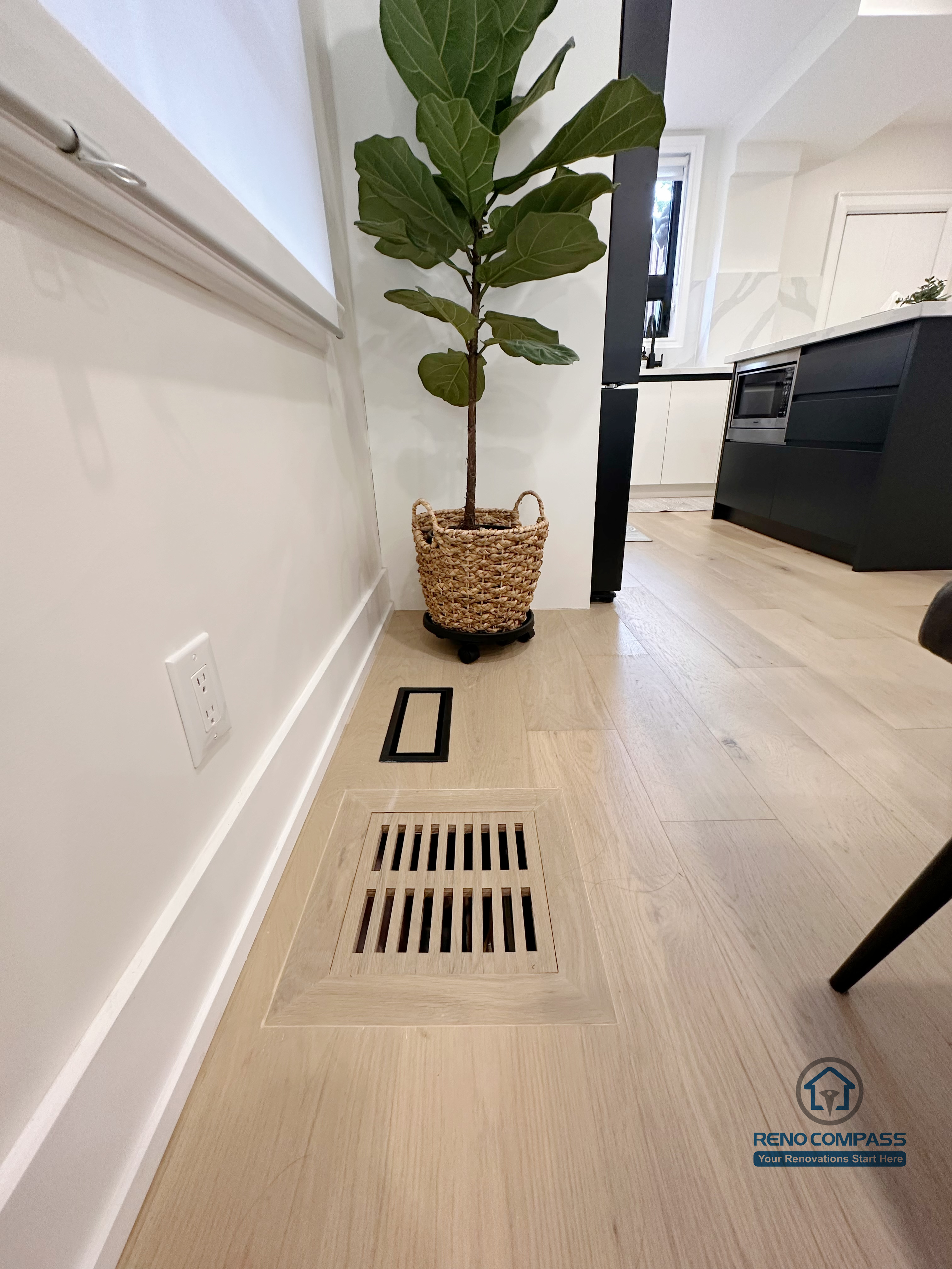 This Toronto interior renovation showcases detailed hardwood flooring installation with a flush-mounted floor vent, clean baseboard finishes, and precise craftsmanship. The seamless integration of ventilation, flooring, and interior elements reflects the attention to detail expected from a professional Toronto renovation company in modern residential projects.