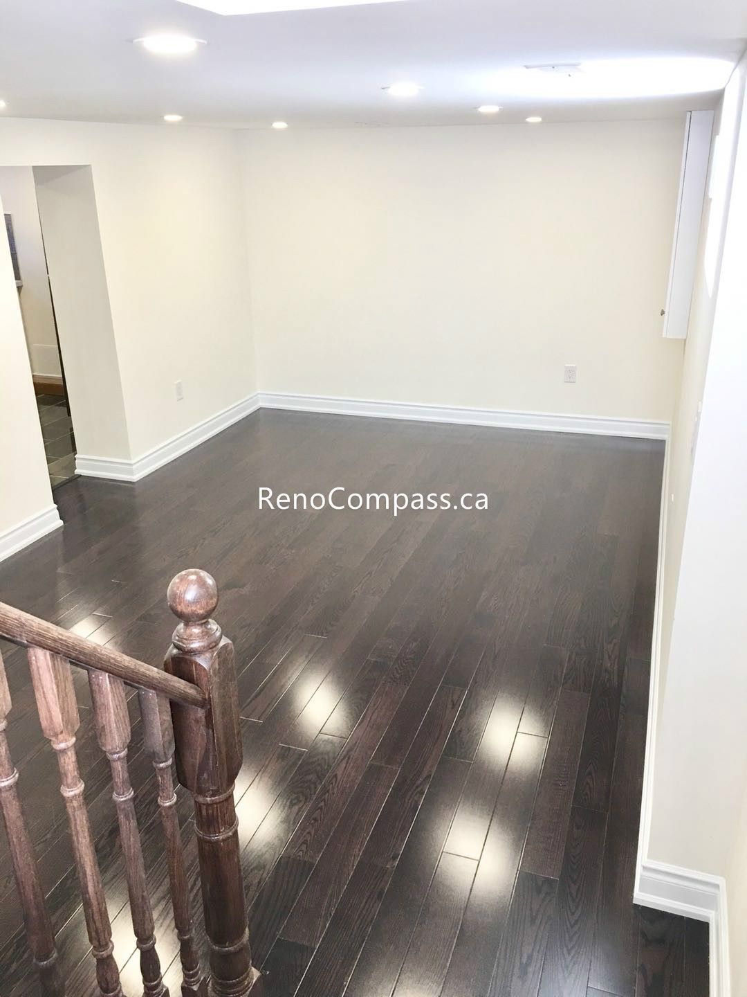 This Toronto basement renovation features newly installed hardwood stairs and matching engineered flooring, creating a clean and modern transition between levels. The upgraded staircase railing and rich wood tones enhance durability, safety, and overall home value. Completed by a professional Toronto renovation company, this project highlights quality craftsmanship and functional design for contemporary basement living spaces.