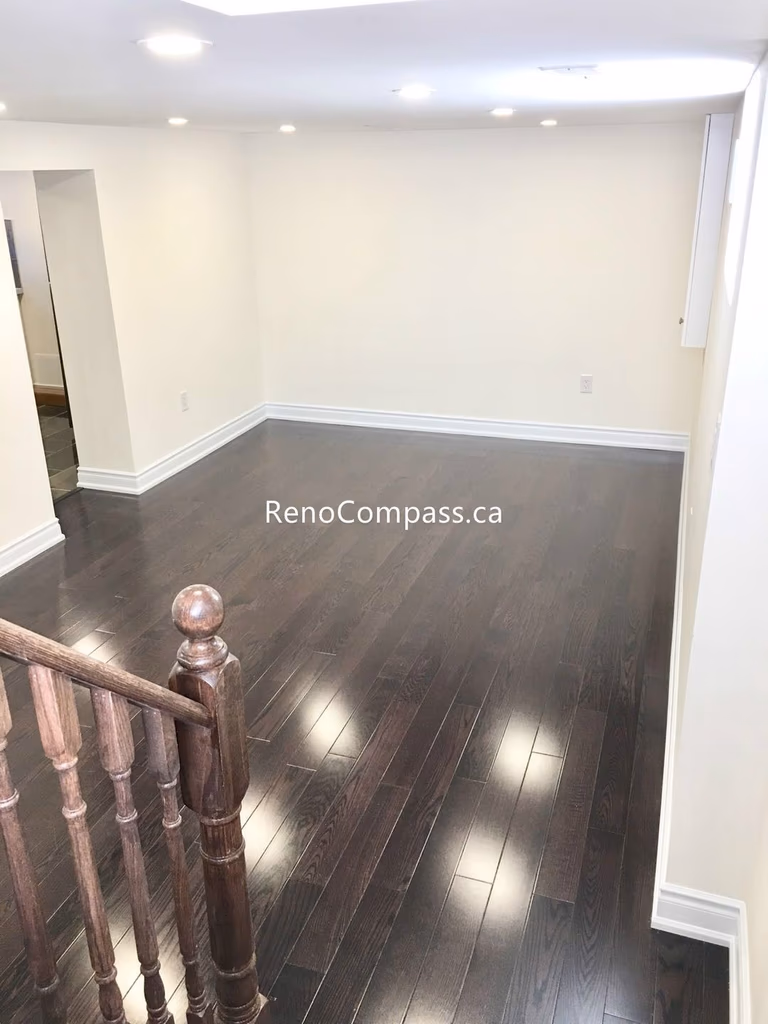 This Toronto basement renovation features newly installed hardwood stairs and matching engineered flooring, creating a clean and modern transition between levels. The upgraded staircase railing and rich wood tones enhance durability, safety, and overall home value. Completed by a professional Toronto renovation company, this project highlights quality craftsmanship and functional design for contemporary basement living spaces.