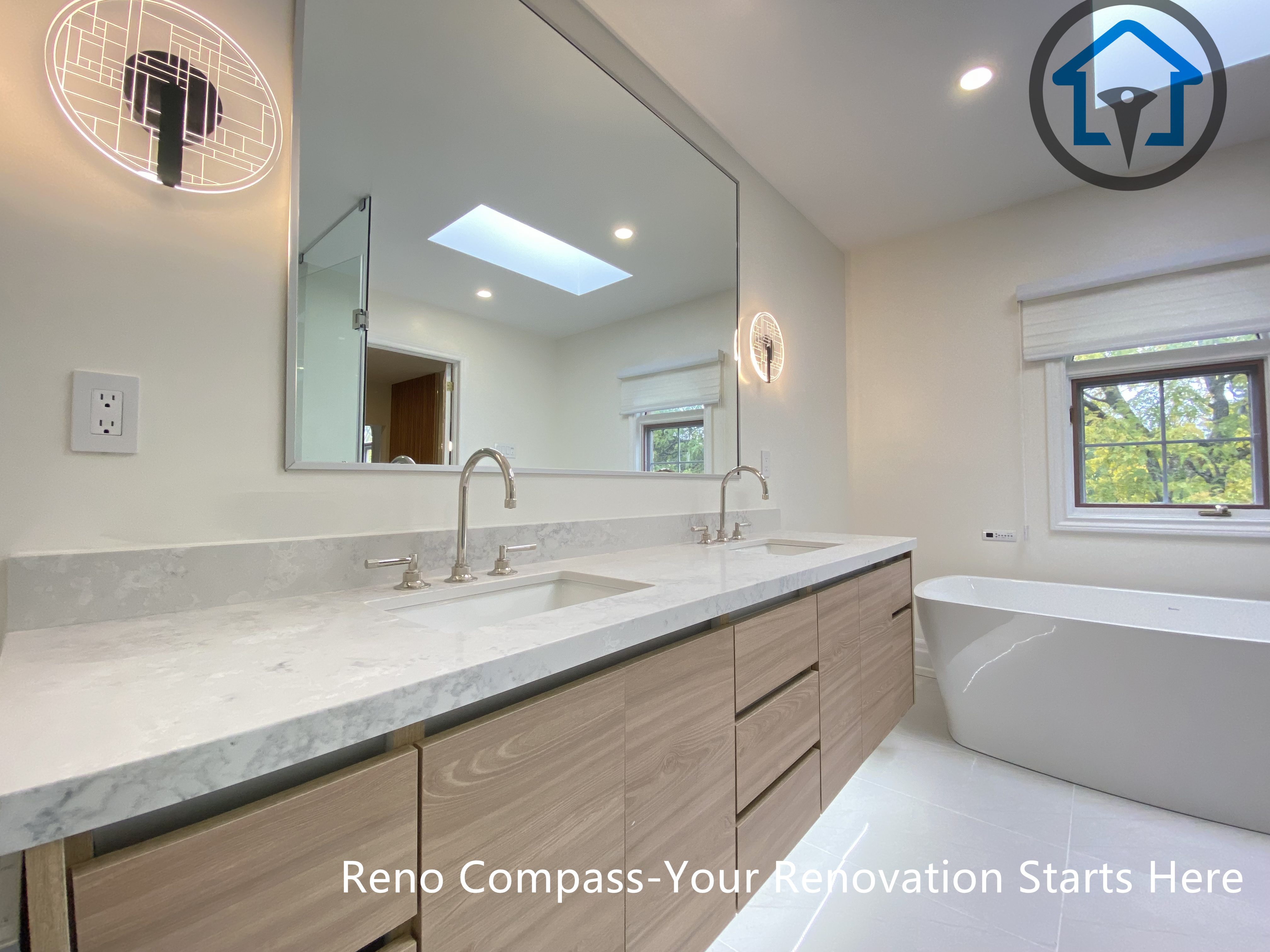 This bathroom renovation features a custom double vanity with integrated lighting, paired with a freestanding bathtub to create a bright and balanced layout. Designed for both functionality and visual clarity in a Thornhill home by Reno Compass.