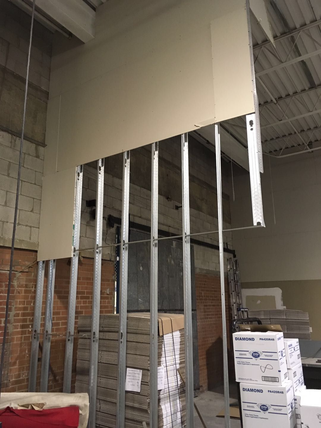 This Toronto factory renovation image showcases ongoing commercial interior construction with professional steel framing and partition wall installation. The project focuses on creating new functional zones within an industrial facility to improve workflow, storage, and operational efficiency. Completed by Reno Compass Inc., a reliable Toronto renovation company specializing in commercial and factory renovations, the upgrade emphasizes durable materials, precise structural framing, and safe construction practices to support long-term industrial use and flexible space planning.