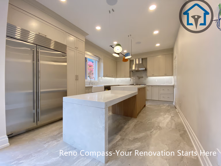 Custom kitchen with island sink, gas range, and tailored cabinetry, completed as part of a Thornhill renovation by Reno Compass.
