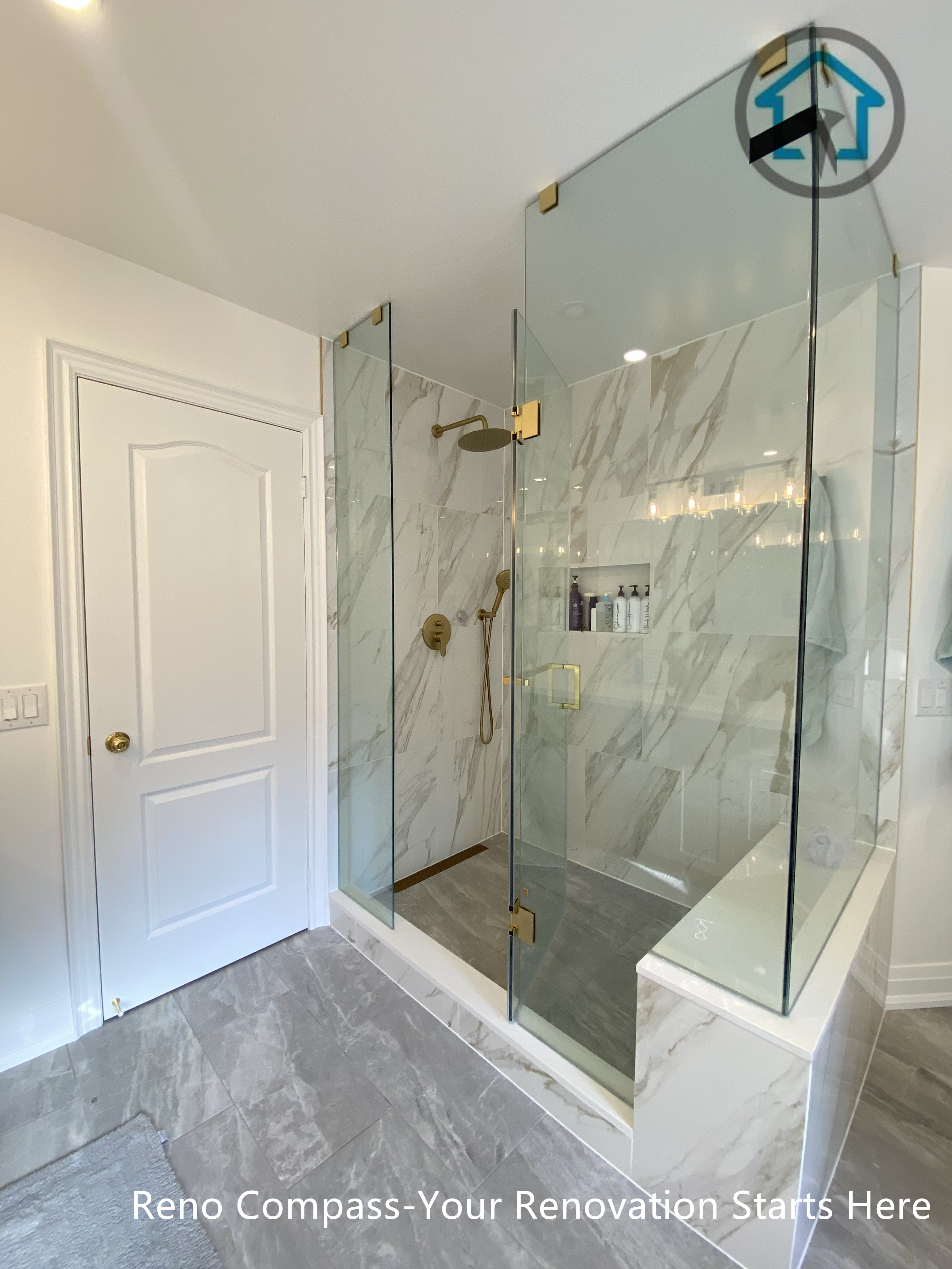 Frameless glass shower with marble-look wall tiles, built-in niche, and clean dry-wet separation in a Markham bathroom renovation.