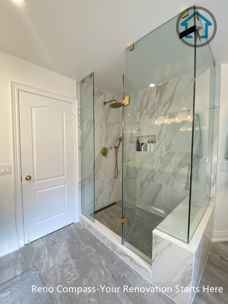 Frameless glass shower with marble-look wall tiles, built-in niche, and clean dry-wet separation in a Markham bathroom renovation.