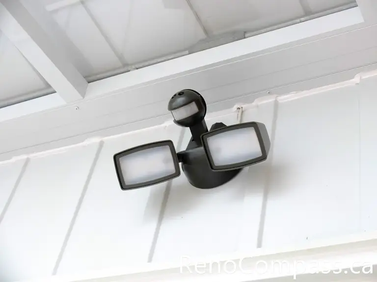 Motion sensor security light installed above a storm door entry in North York, enhancing nighttime visibility and entrance safety. This lighting feature improves everyday convenience while adding an extra layer of security to the glass entry enclosure. Professionally mounted to integrate with the covered entry structure, the sensor light supports safe access and complements the overall storm door installation.