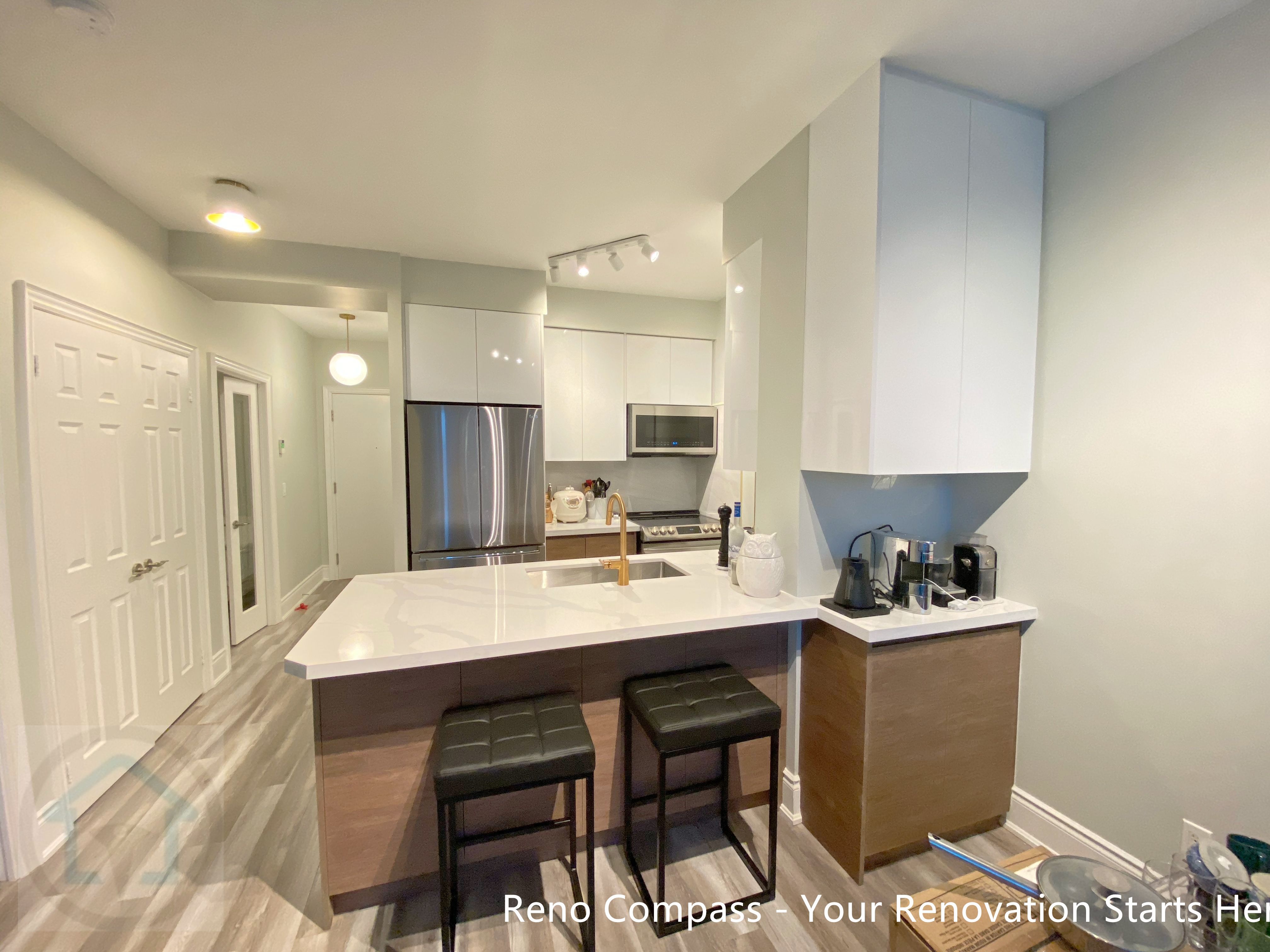 This modern condo kitchen renovation in North York features a clean-lined island design with integrated seating, warm wood-tone cabinetry, and a durable quartz countertop. The island serves as both a functional prep space and a casual dining area, enhancing daily usability while maintaining a streamlined, contemporary look. Thoughtful material selection and balanced proportions ensure the space feels open, practical, and well-suited for condo living.
