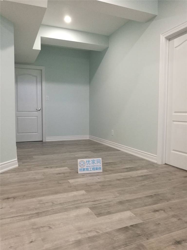 This newly finished basement room in Vaughan features durable wood-look flooring, smooth neutral walls, and recessed ceiling lighting to create a clean and contemporary space. Completed by a professional Toronto renovation company, the basement upgrade enhances functionality and comfort, making it ideal for a guest room, home office, or additional living area.