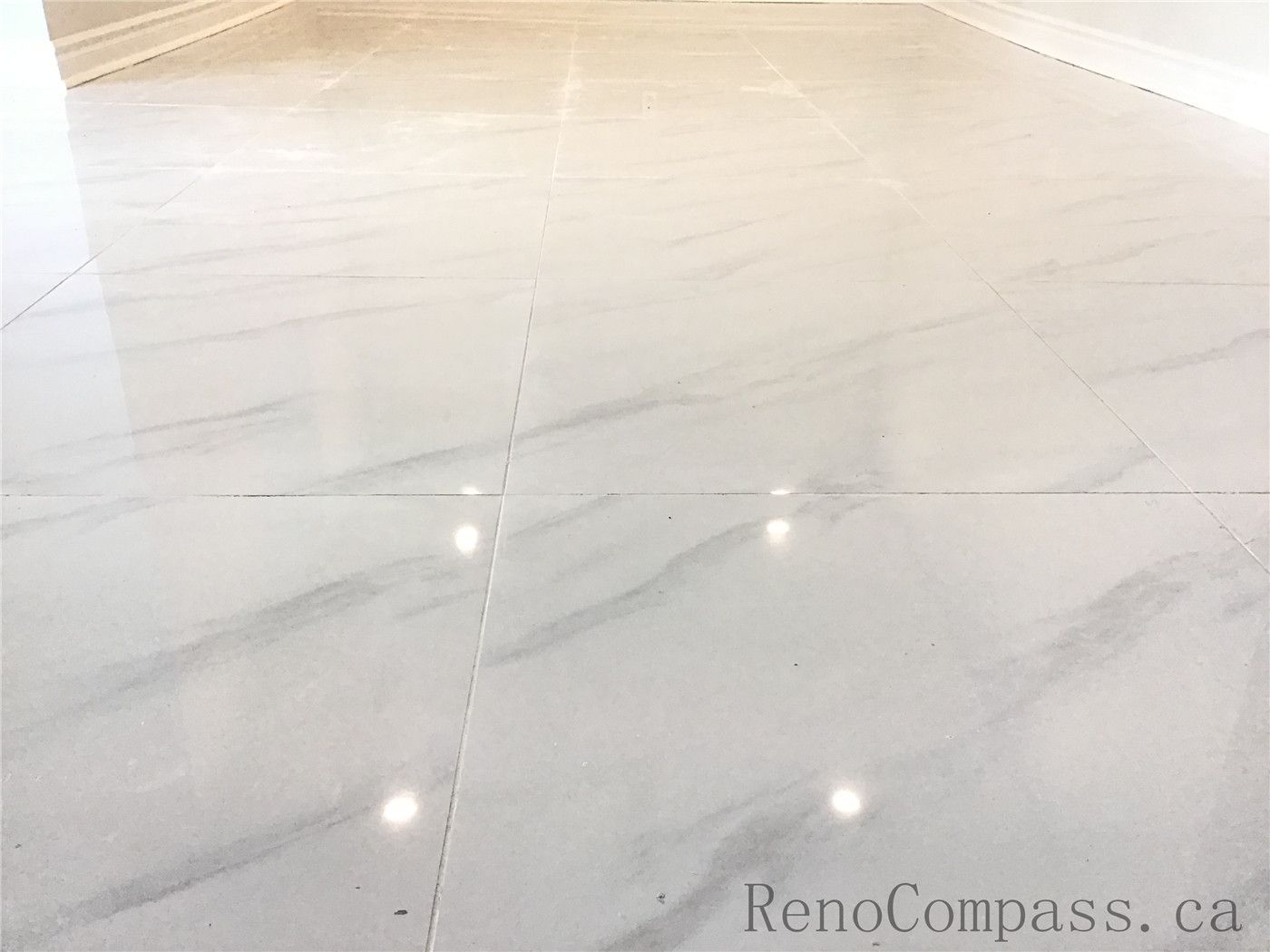 This Whitby basement renovation features large-format marble-look porcelain tiles with a high-gloss finish, creating a bright and elegant foundation for the space. The precise tile alignment and smooth grout lines enhance the modern aesthetic while ensuring durability and easy maintenance — a perfect flooring solution for a fully upgraded basement.

If you upload the next image, I’ll continue with the SEO titles and descriptions for each one.