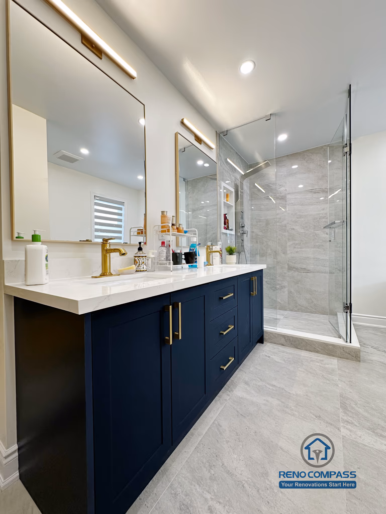 Master bathroom renovation in Markham featuring a frameless glass shower, large-format tile finishes, a custom vanity with matte black cabinetry, and brass fixtures. The design combines clean lines, efficient layout, and a refined modern aesthetic for everyday comfort.
