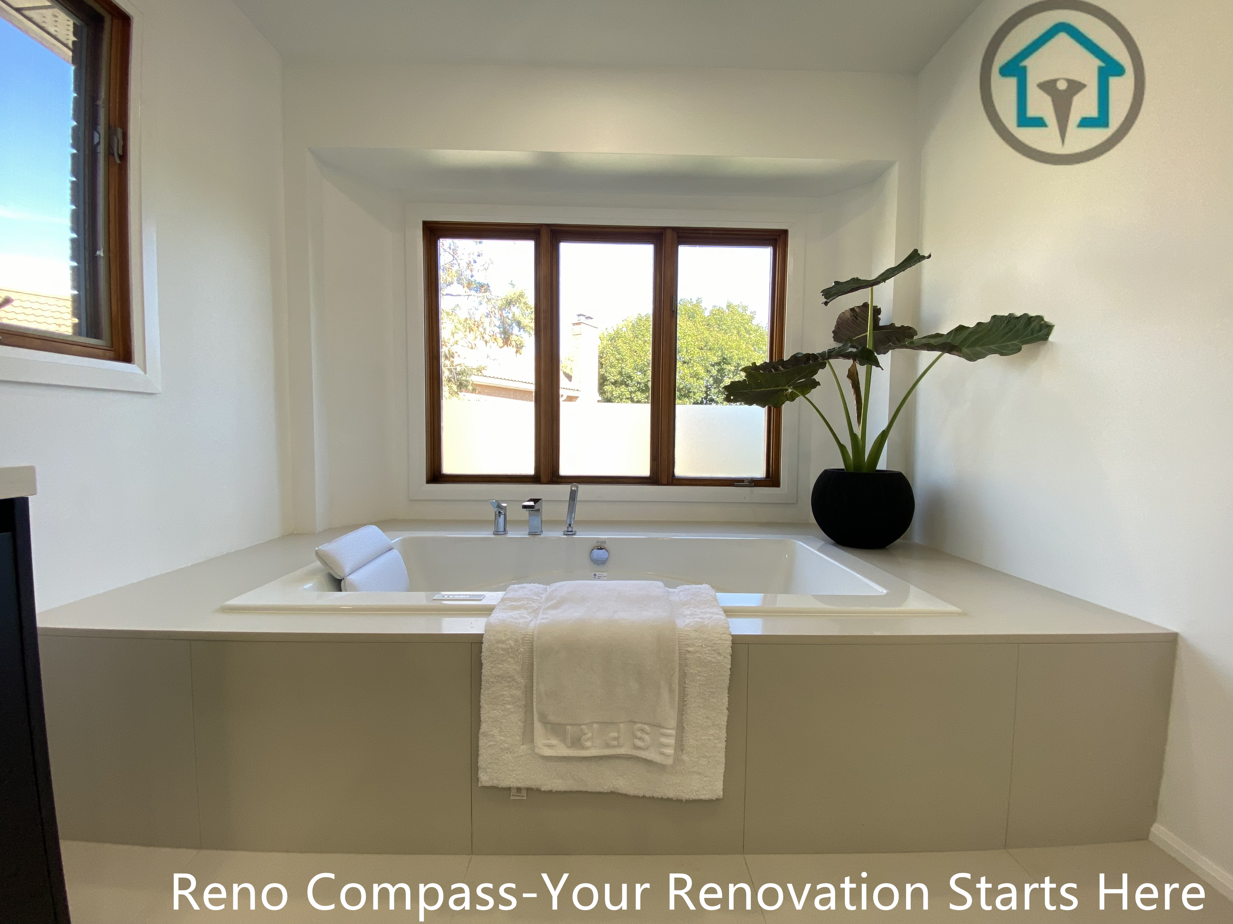 Modern bathroom renovation in Brampton featuring a built-in soaking bathtub, clean-lined surround, and large window bringing in natural daylight. The design emphasizes relaxation, simplicity, and spatial balance, completed by a professional Toronto renovation company.