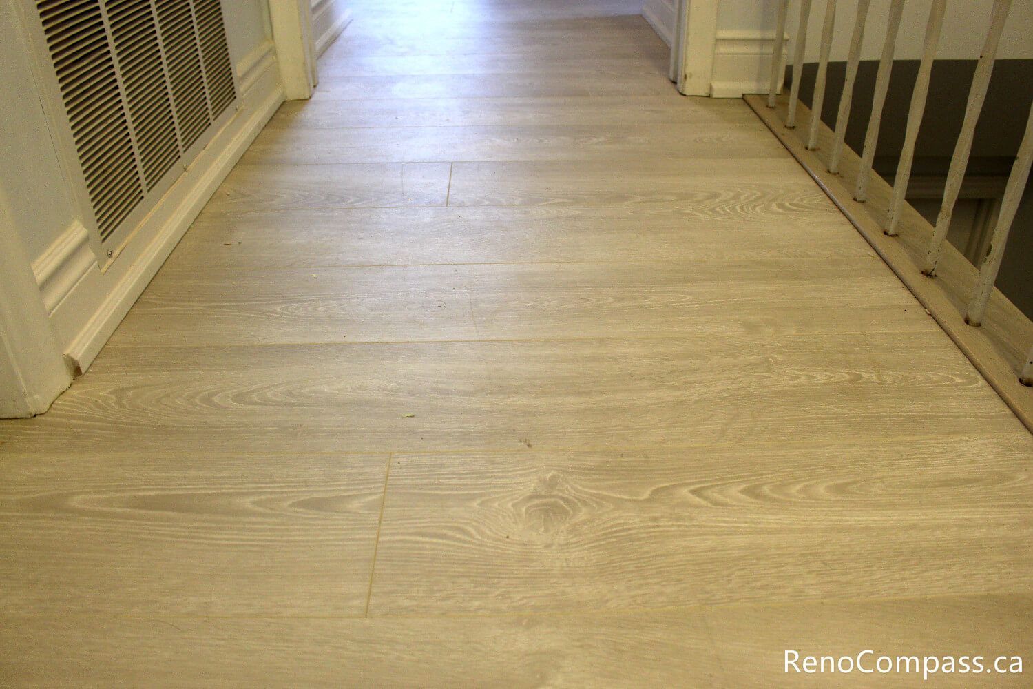 Seamless wide-plank flooring installation in a hallway and landing area for an Oshawa home renovation. Reno Compass provides expert flooring services in the Durham Region, featuring durable, modern finishes that flow perfectly between rooms and staircases.