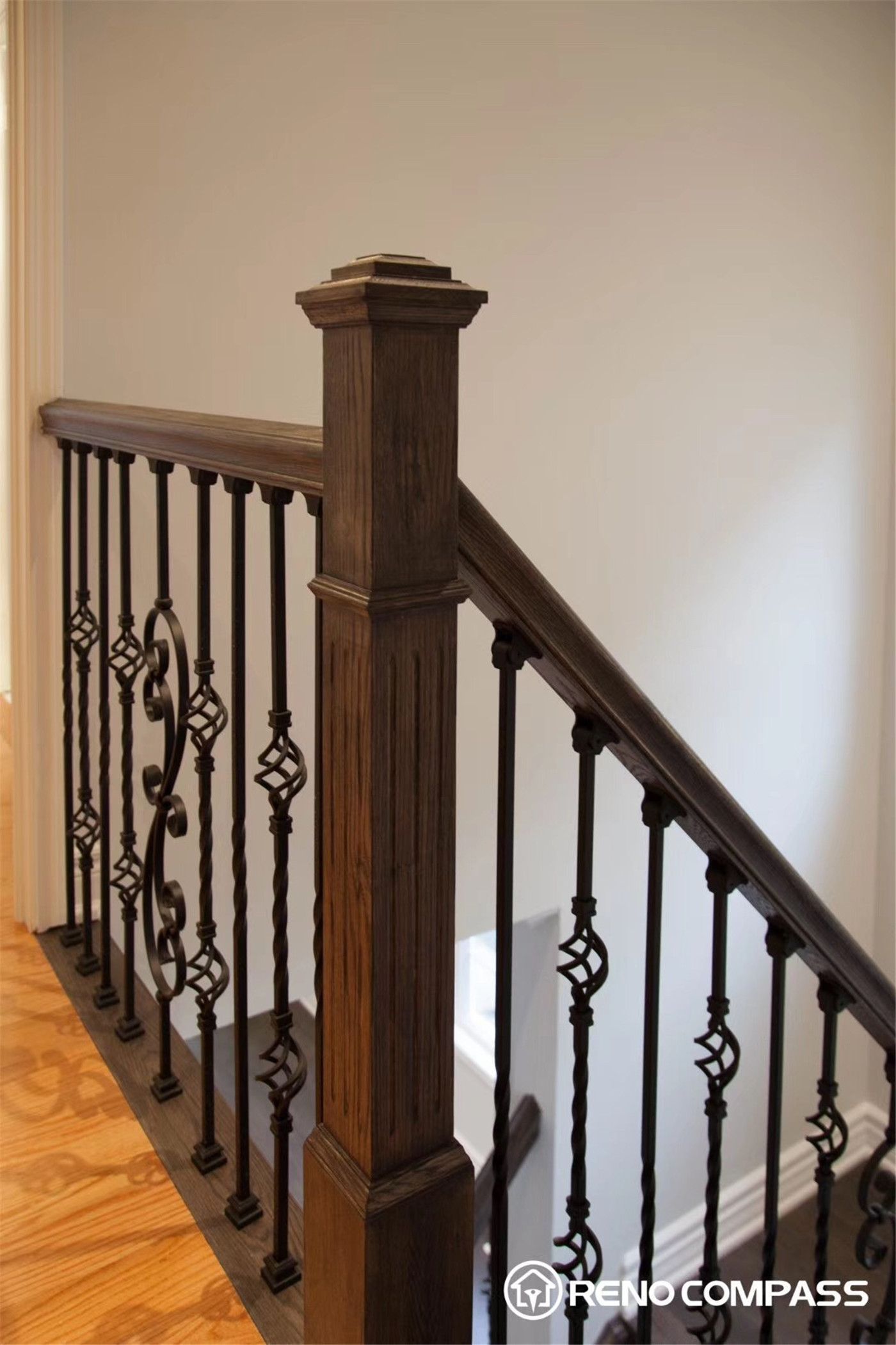 This Markham interior renovation highlights a beautifully crafted staircase featuring rich solid wood steps paired with elegant wrought iron balusters. The combination of warm wood tones and intricate metal detailing creates a timeless yet modern look, enhancing both the functionality and visual appeal of the home.