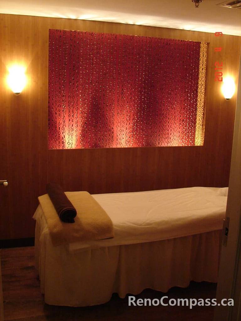 This Toronto beauty spa renovation features a serene treatment room designed for relaxation and comfort. Warm wood panel walls, soft ambient lighting, and a custom illuminated feature wall create a calming, boutique-style environment for facial and body treatments. Thoughtfully designed to enhance both aesthetics and functionality, this commercial beauty interior reflects modern spa design and professional craftsmanship by an experienced Toronto renovation company.