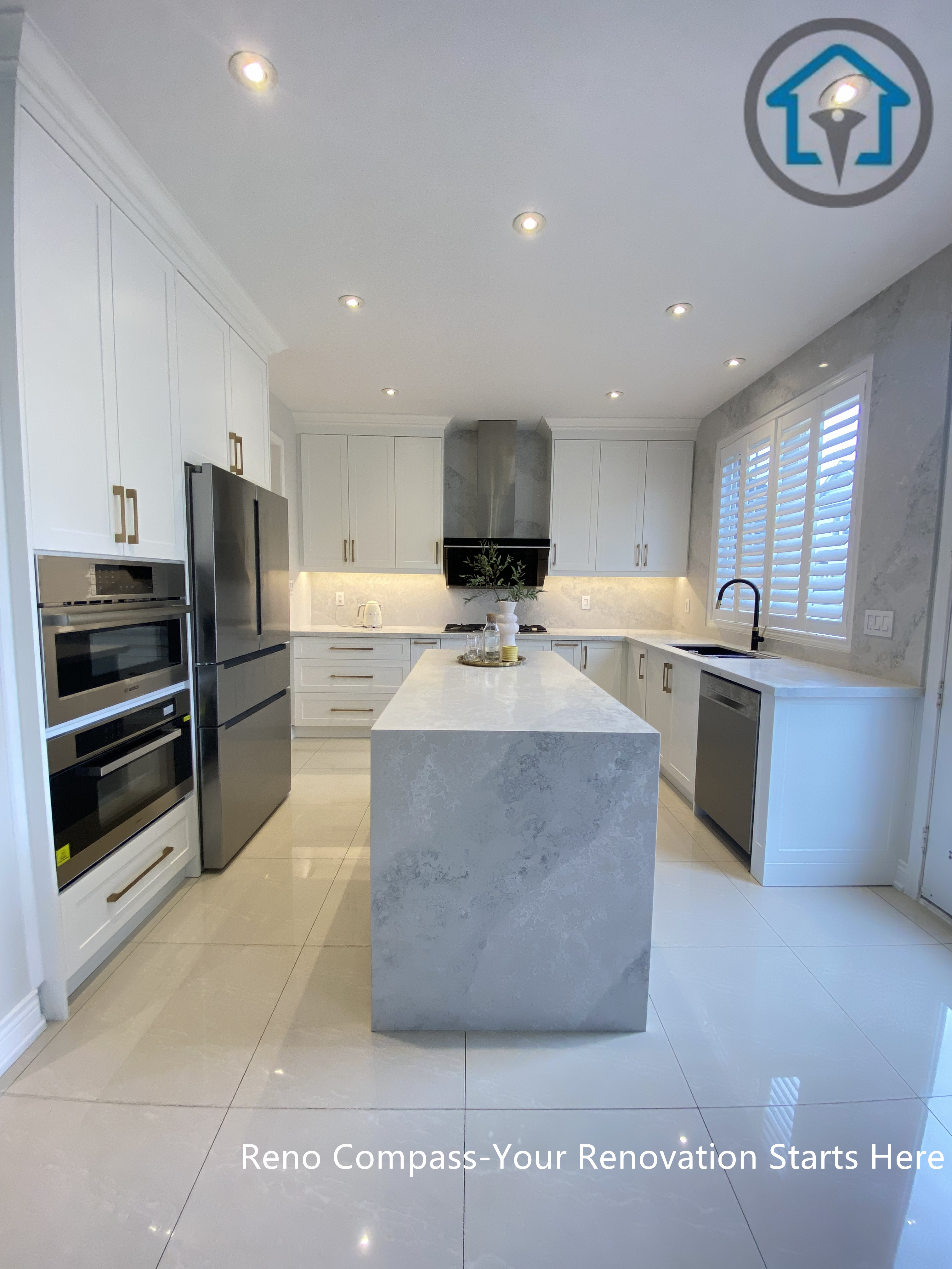 This image highlights the kitchen island and built-in appliance wall in this Markham kitchen renovation. Custom cabinetry integrates a refrigerator and wall oven seamlessly, while the central island provides additional prep space and storage. The balanced layout and consistent finishes create a clean, cohesive kitchen designed for everyday use. Designed and completed by Reno Compass, this project reflects a refined and practical approach to kitchen renovation in Markham.