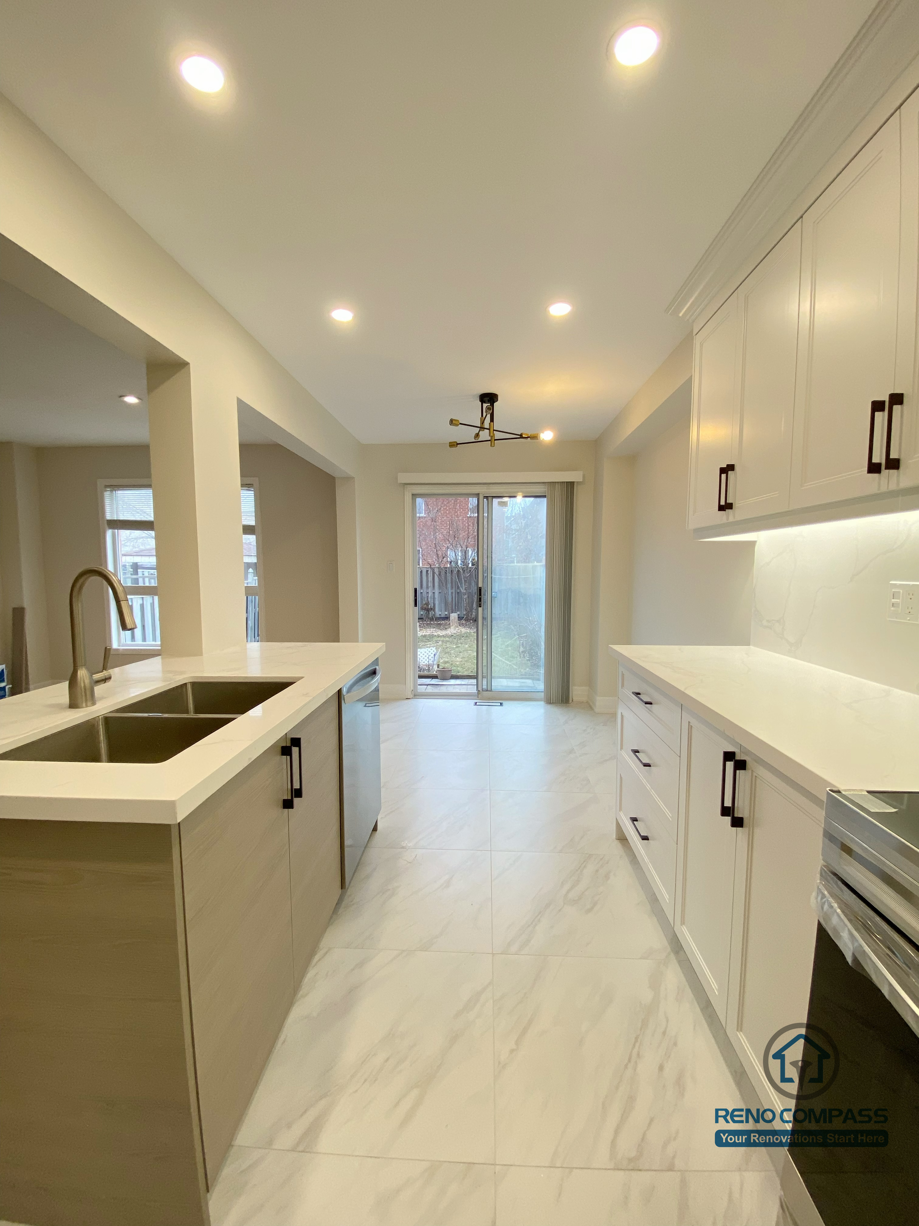 This Markham interior renovation features a bright open-concept kitchen with custom white cabinetry, quartz countertops, a functional center island, and recessed ceiling lighting. The clean layout seamlessly connects the kitchen to the living area, enhancing both space flow and natural light. Designed and completed by a professional Toronto renovation company, this project focuses on modern aesthetics, daily functionality, and long-term durability for homeowners in Markham.