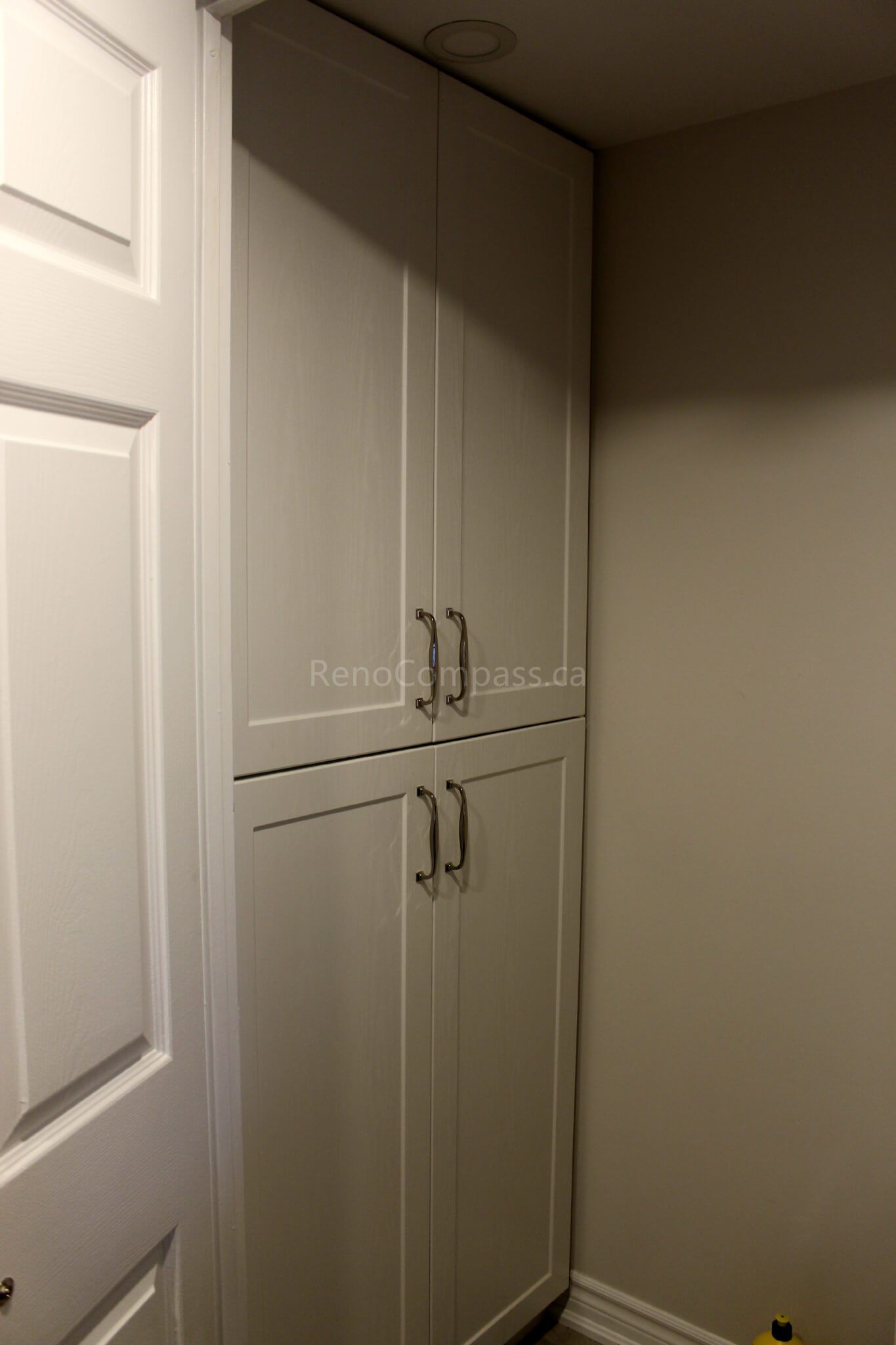 This Mississauga interior renovation features custom-built storage cabinets designed to maximize vertical space and improve home organization. The clean white cabinetry with modern handles provides a seamless built-in look, enhancing both functionality and aesthetics. Completed by Reno Compass, a trusted Toronto renovation company, this project highlights practical storage solutions for modern residential interiors across the GTA.