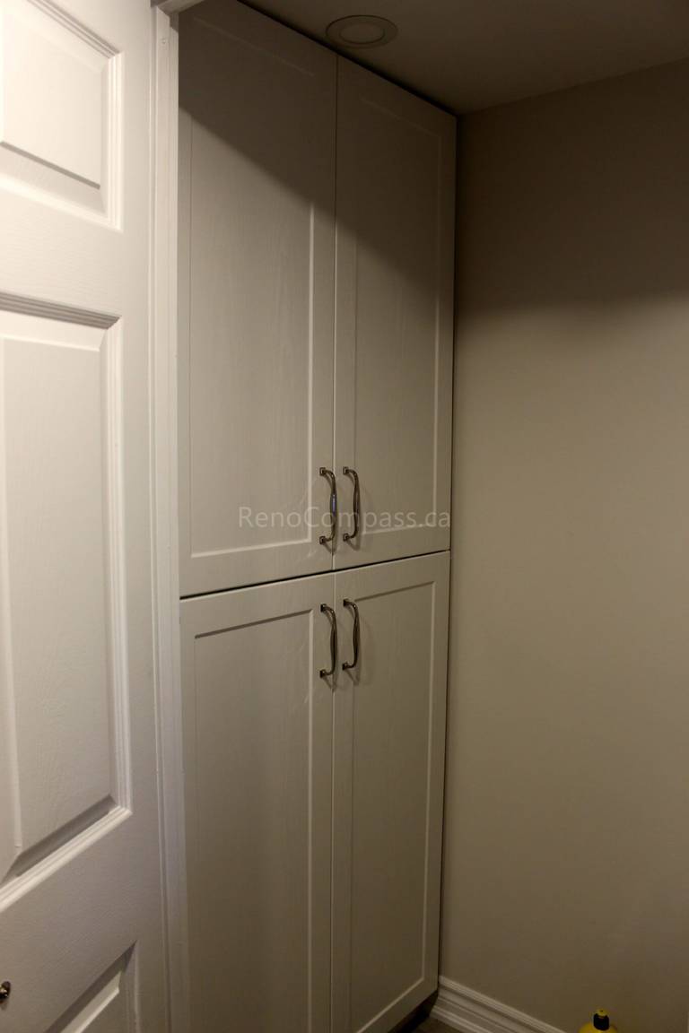 This Mississauga interior renovation features custom-built storage cabinets designed to maximize vertical space and improve home organization. The clean white cabinetry with modern handles provides a seamless built-in look, enhancing both functionality and aesthetics. Completed by Reno Compass, a trusted Toronto renovation company, this project highlights practical storage solutions for modern residential interiors across the GTA.