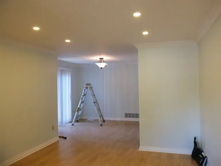 This Oshawa interior renovation project showcases a bright and refreshed open-concept living and dining area. The space features newly refinished hardwood flooring, smooth ceiling with recessed pot lights, upgraded crown molding, and a clean neutral wall palette to enhance natural light. The updated lighting layout improves functionality while creating a warm and inviting atmosphere. Completed with precision and attention to detail, this project reflects the professional craftsmanship of a trusted Toronto Renovation Company, delivering a modern and cohesive interior transformation.