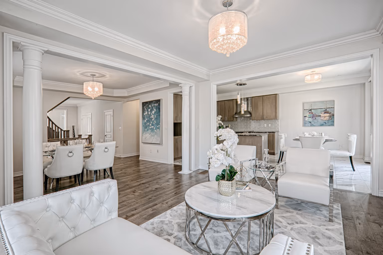 This Toronto luxury open-concept interior renovation showcases a seamless flow between the living room, dining area, and kitchen with elegant modern classic design. Featuring premium hardwood flooring, custom columns, refined ceiling details, and high-end lighting fixtures, the space creates a bright and sophisticated residential environment. Completed by a professional Toronto renovation company, this whole-house interior project highlights functional layout planning, upscale finishes, and timeless design tailored for modern family living.