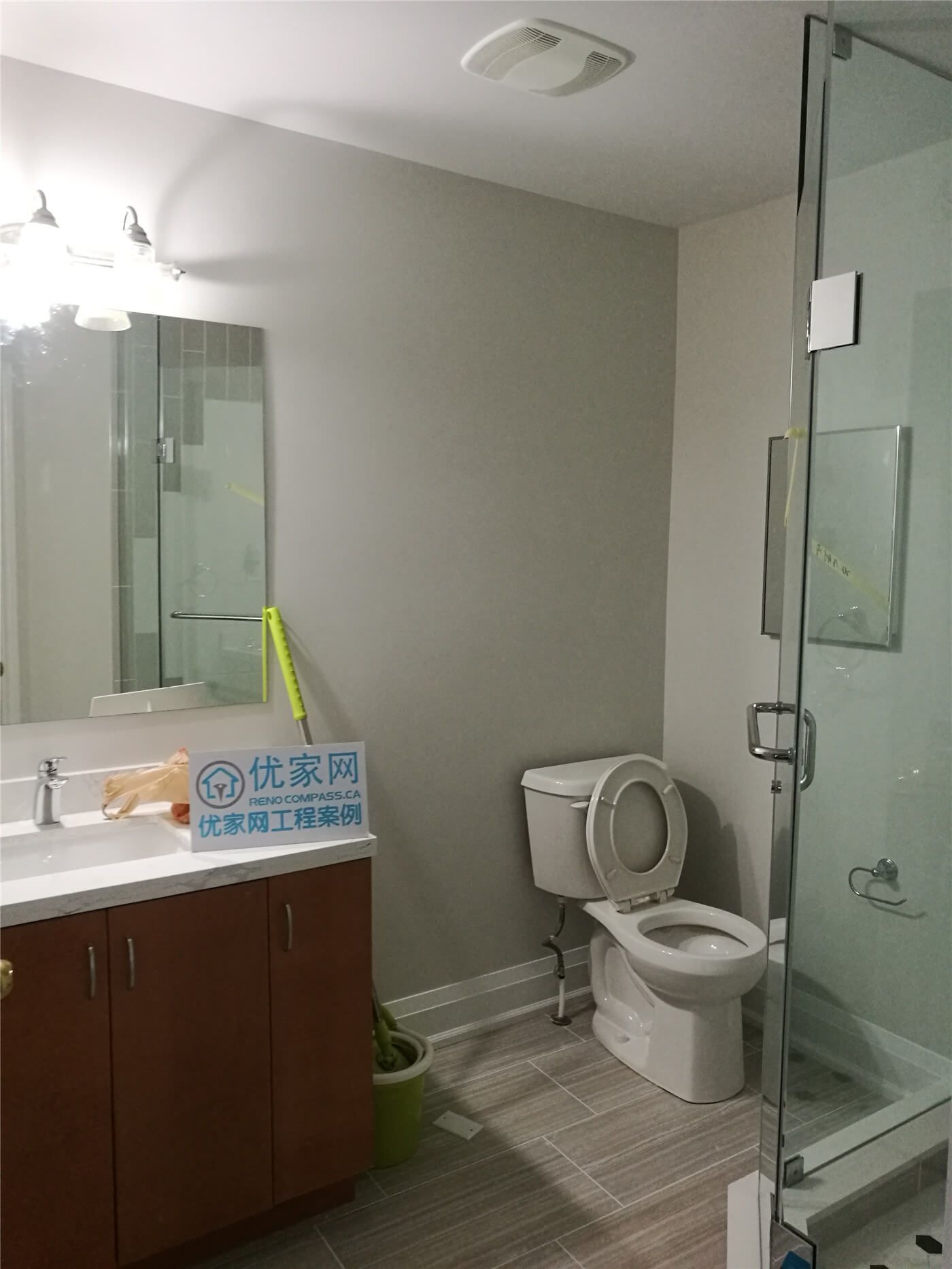 This Markham basement bathroom renovation features a modern glass shower enclosure, updated vanity with integrated sink, neutral wall finishes, and durable floor tiles. Completed by Reno Compass Inc., the space is refreshed to improve functionality, comfort, and a clean modern look for everyday use.