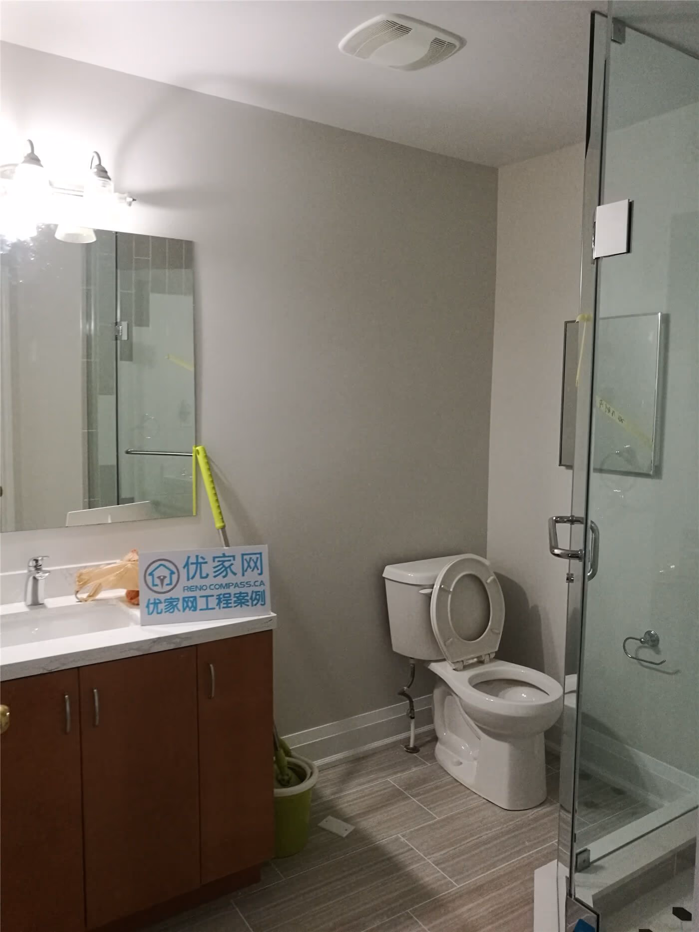 This Markham basement bathroom renovation features a modern glass shower enclosure, updated vanity with integrated sink, neutral wall finishes, and durable floor tiles. Completed by Reno Compass Inc., the space is refreshed to improve functionality, comfort, and a clean modern look for everyday use.