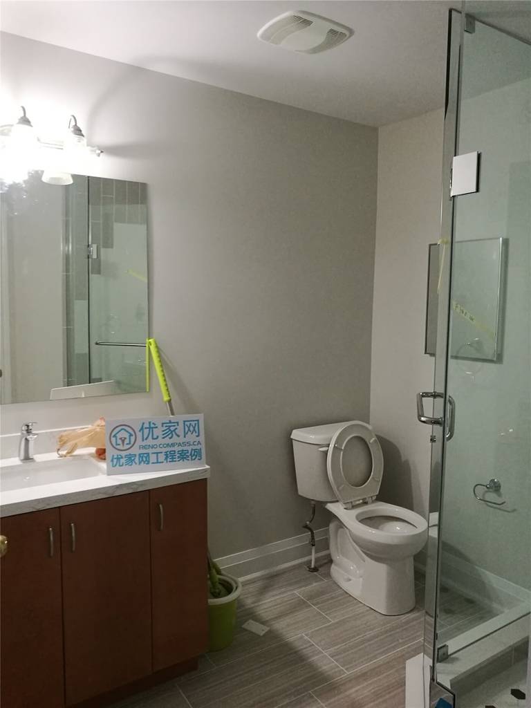 This Markham basement bathroom renovation features a modern glass shower enclosure, updated vanity with integrated sink, neutral wall finishes, and durable floor tiles. Completed by Reno Compass Inc., the space is refreshed to improve functionality, comfort, and a clean modern look for everyday use.