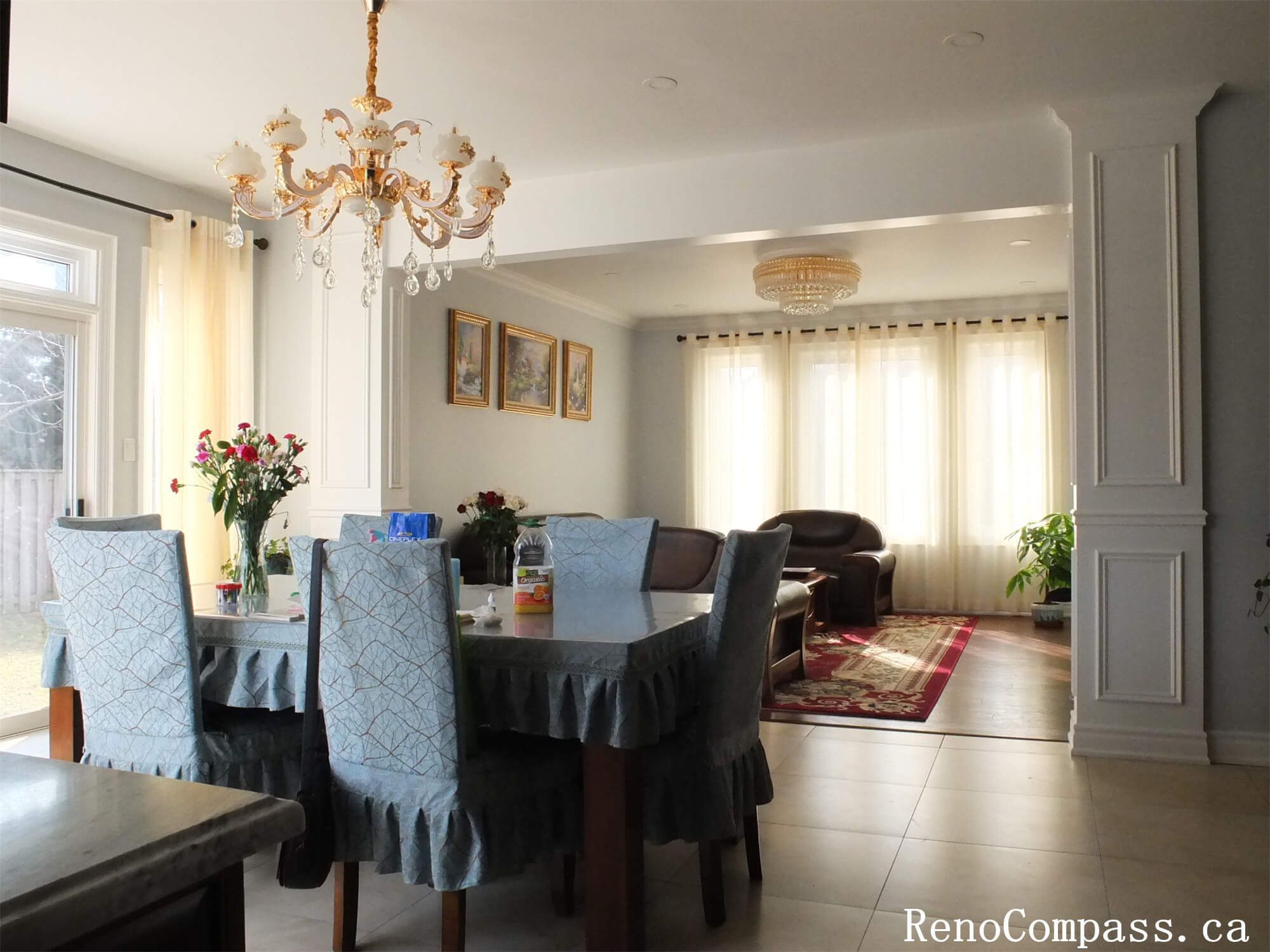 This Richmond Hill interior renovation project features a bright open-concept living and dining area created by removing a wall between the kitchen and living room. The renovation also included repainting the staircase, upgrading multiple bathrooms, and improving the overall layout to create a more spacious and elegant family environment.