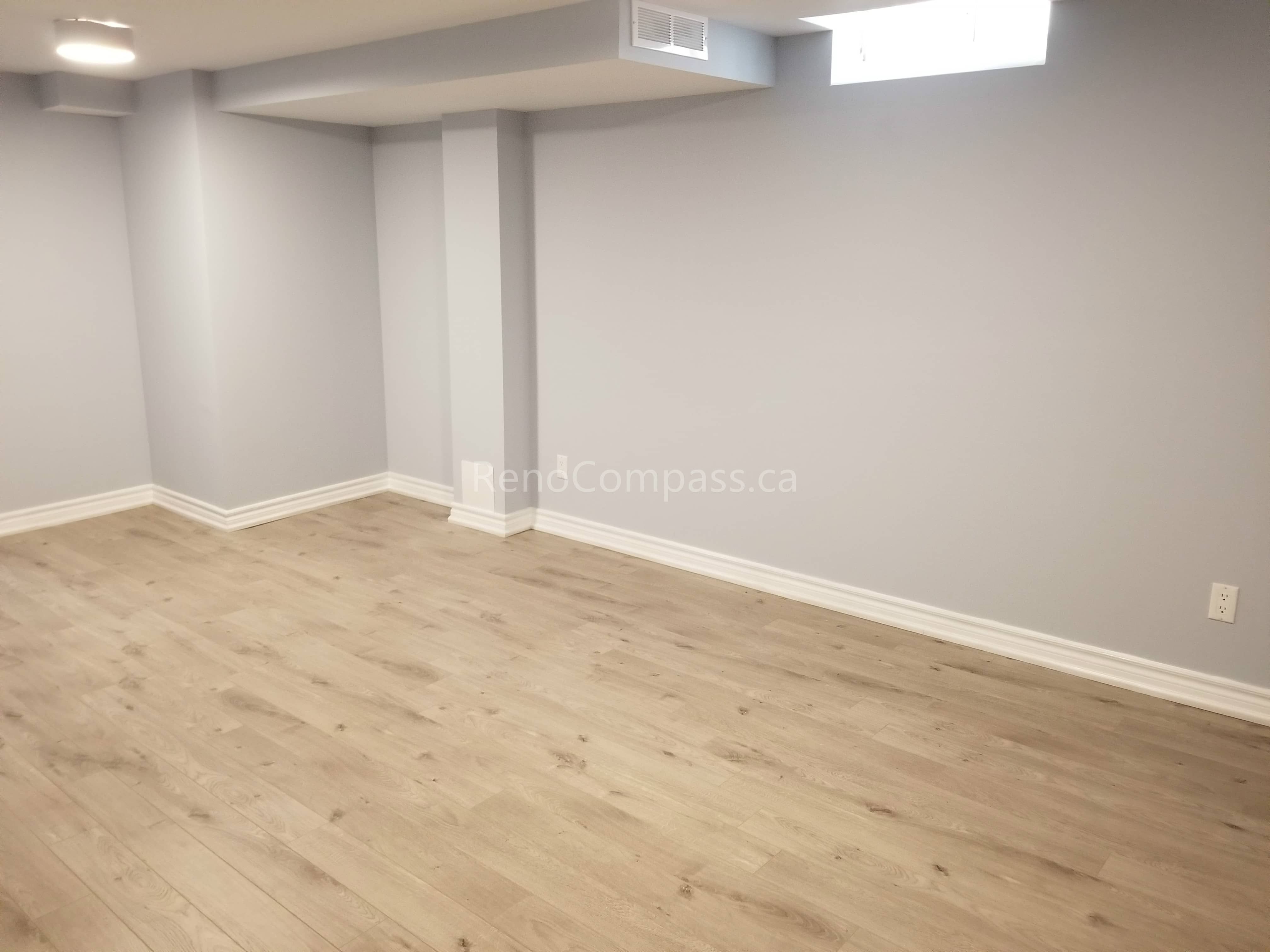 This Mississauga basement renovation features a clean, modern open-concept layout with newly installed light-tone flooring and fresh neutral wall finishes. The upgraded space offers improved brightness, comfort, and functionality, creating a versatile area suitable for family living, entertainment, or rental potential.

Completed by Reno Compass Inc., this basement upgrade highlights quality flooring installation, refined finishing details, and professional craftsmanship to enhance both usability and property value.
