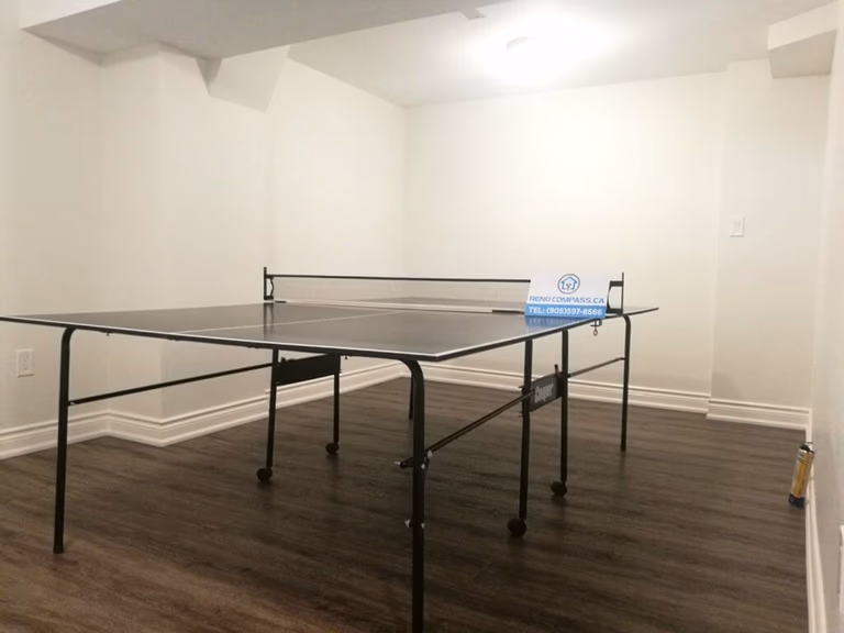 This Markham basement renovation transforms an underused space into a clean and functional multi-purpose entertainment area. The finished basement features durable wood-look flooring, smooth white walls, upgraded lighting, and an open layout suitable for games, family activities, or home recreation. Completed by a professional Toronto renovation company, this basement renovation focuses on comfort, flexibility, and long-term usability for everyday living.