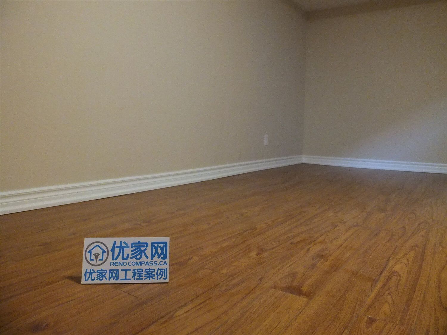 This Markham basement renovation project features newly finished walls, fresh interior painting, and durable laminate flooring installation. The clean wall finish, neutral paint tones, and wood-style flooring create a bright, comfortable living space suitable for a family recreation room or additional living area. Careful detailing around the baseboards and wall edges ensures a smooth and polished appearance throughout the basement interior.