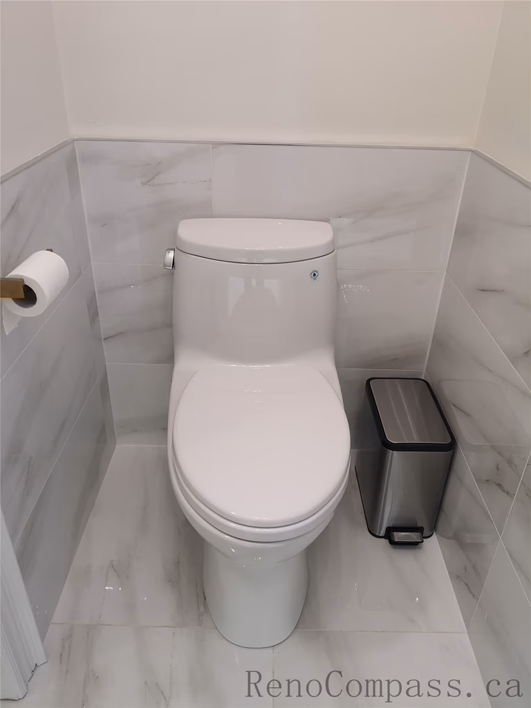 This Aurora bathroom renovation features a clean and modern toilet installation with marble-style wall and floor tiles for a bright, elegant finish. The space is designed for durability, easy maintenance, and a timeless aesthetic, combining functional layout with refined details. Completed by a professional Toronto renovation company focused on quality workmanship and contemporary interior upgrades.