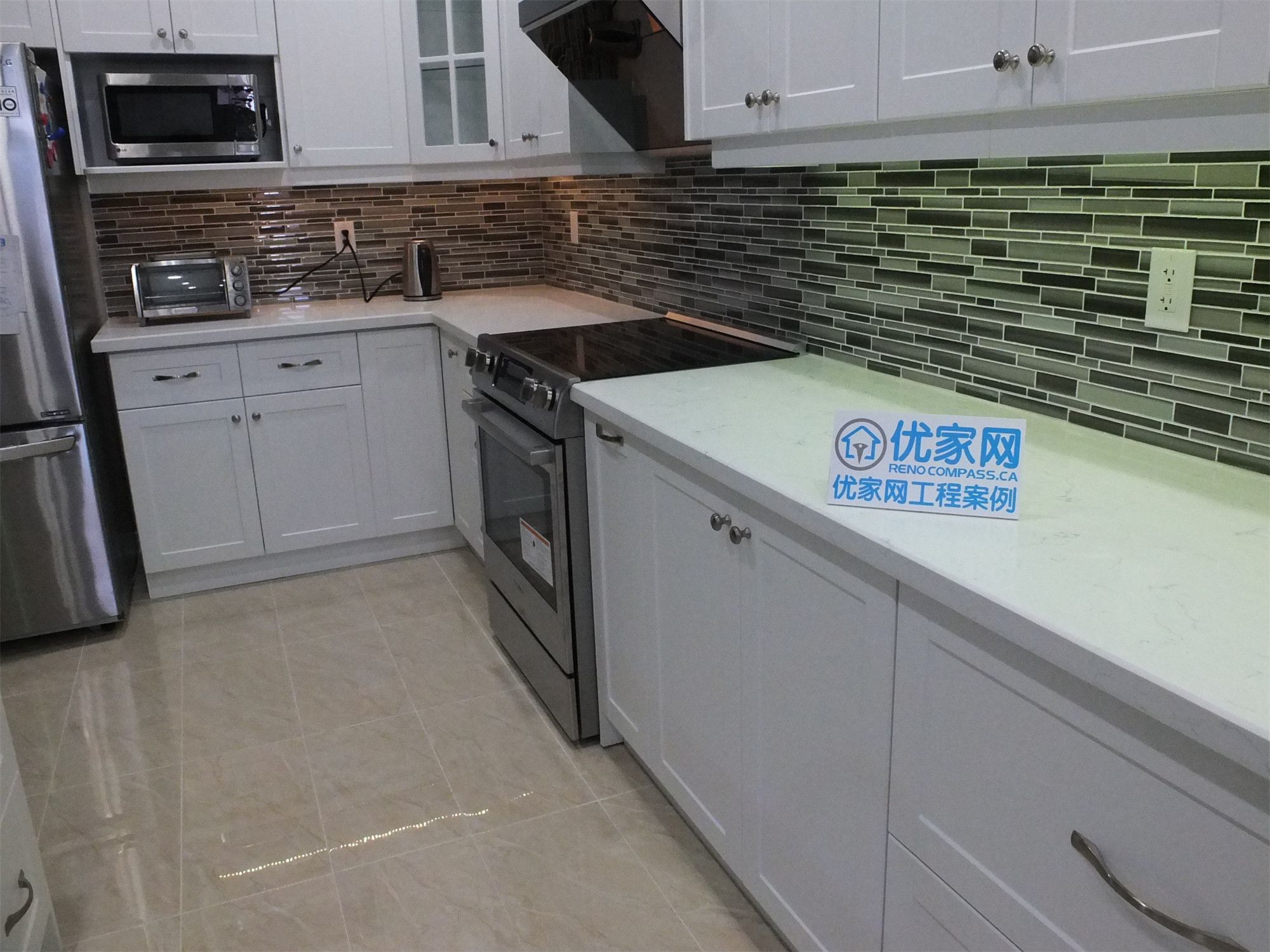 This kitchen renovation project in Vaughan showcases clean white shaker cabinetry, durable quartz countertops, stainless steel appliances, and a stylish mosaic tile backsplash. The upgraded layout improves both functionality and visual appeal, creating a bright and practical cooking environment. Completed by a professional Toronto renovation company, the design blends modern aesthetics with efficient everyday use.