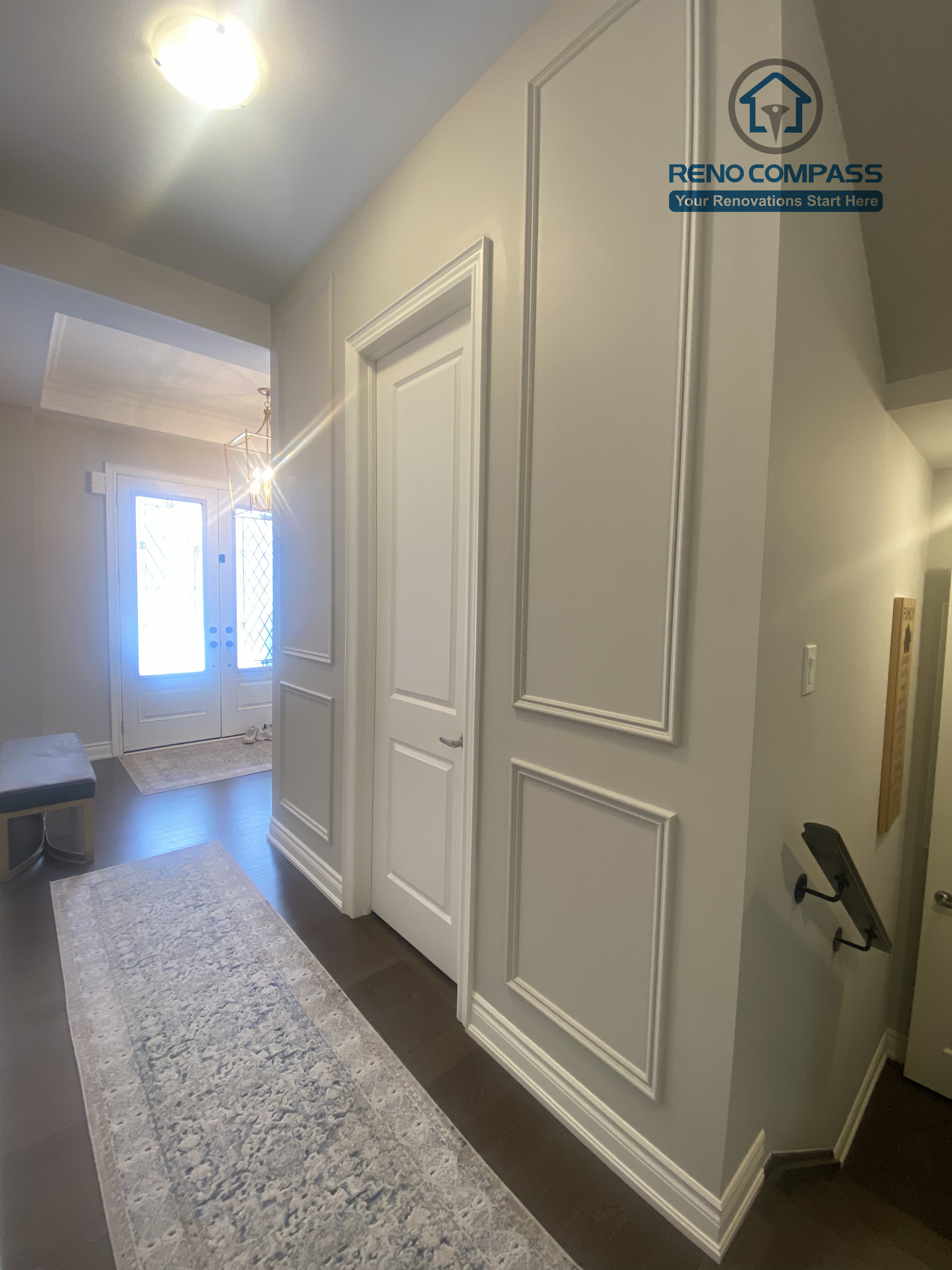 This Vaughan interior renovation highlights a refined hallway featuring built-in storage doors, classic wall paneling, and clean trim details. The space is designed with balanced proportions and subtle lighting, enhancing both functionality and elegance, completed by a professional Toronto renovation company.