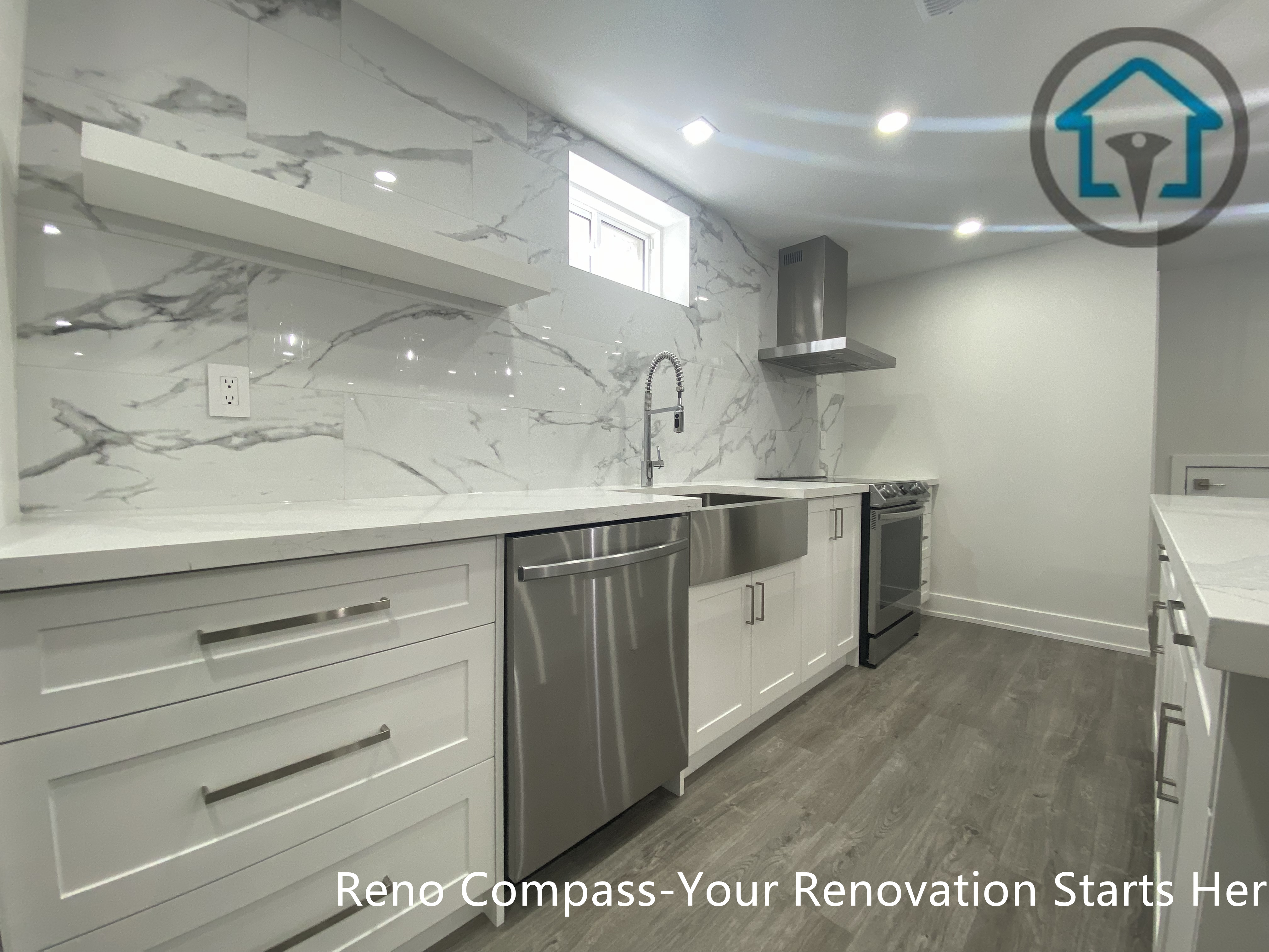This image showcases a modern basement kitchen renovation in Newmarket completed by a trusted Toronto renovation company. The design features full-height marble-look backsplash tiles, custom white shaker cabinets, quartz countertops, and stainless steel appliances including a built-in dishwasher and range hood. The clean lines, neutral tones, and durable flooring create a functional and visually cohesive basement kitchen suitable for rental units or extended family living.