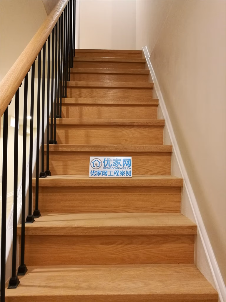 Basement staircase renovation in Markham featuring solid wood stair treads, modern black metal railings, and clean neutral wall finishes. This upgrade enhances safety, durability, and visual appeal, creating a seamless transition between levels. Completed by a reliable Toronto renovation company serving Markham and the GTA.