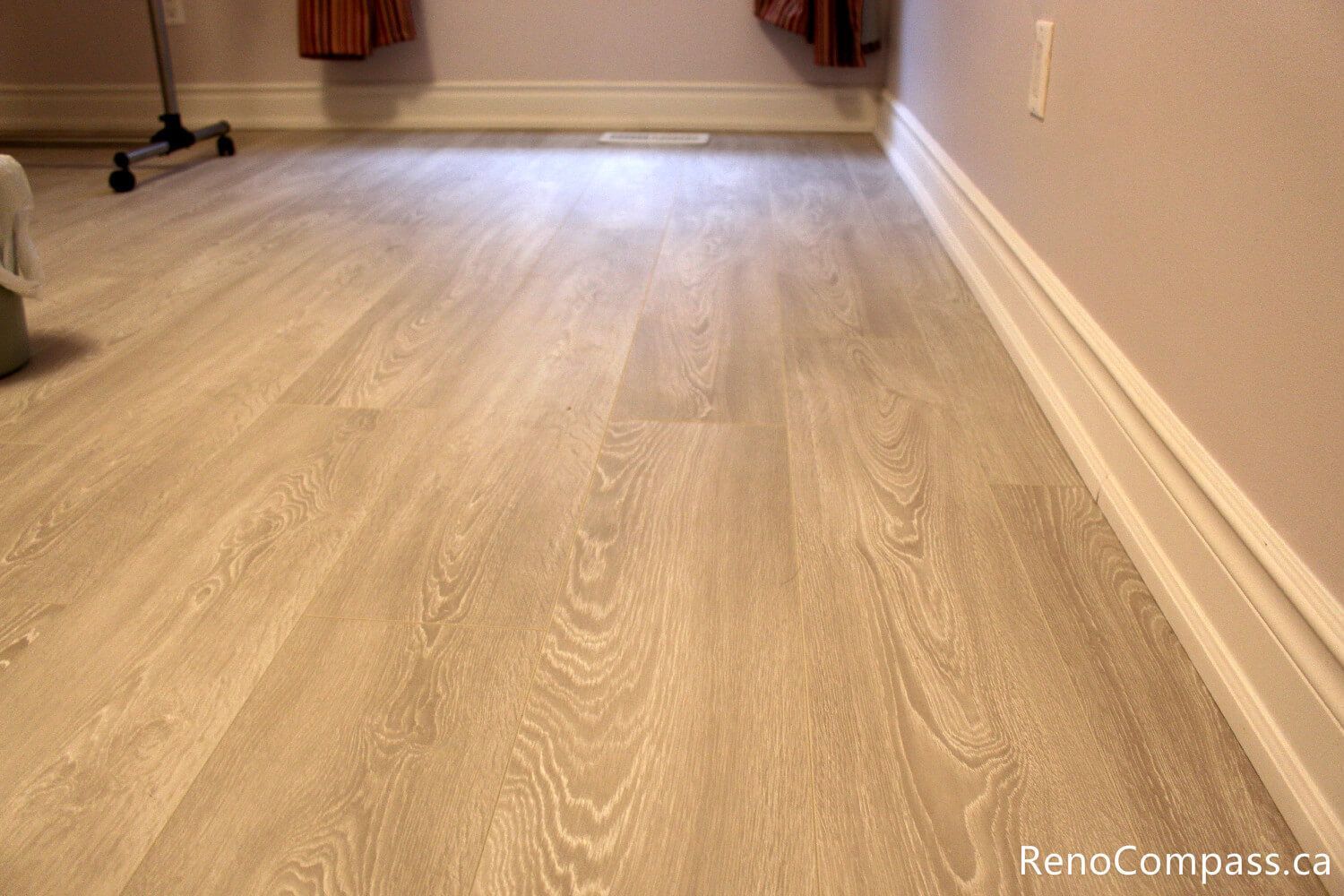 A close-up showcase of professional baseboard installation and seamless flooring transitions in an Oshawa home. Reno Compass ensures high-quality craftsmanship in every corner, providing clean lines for a polished interior renovation.