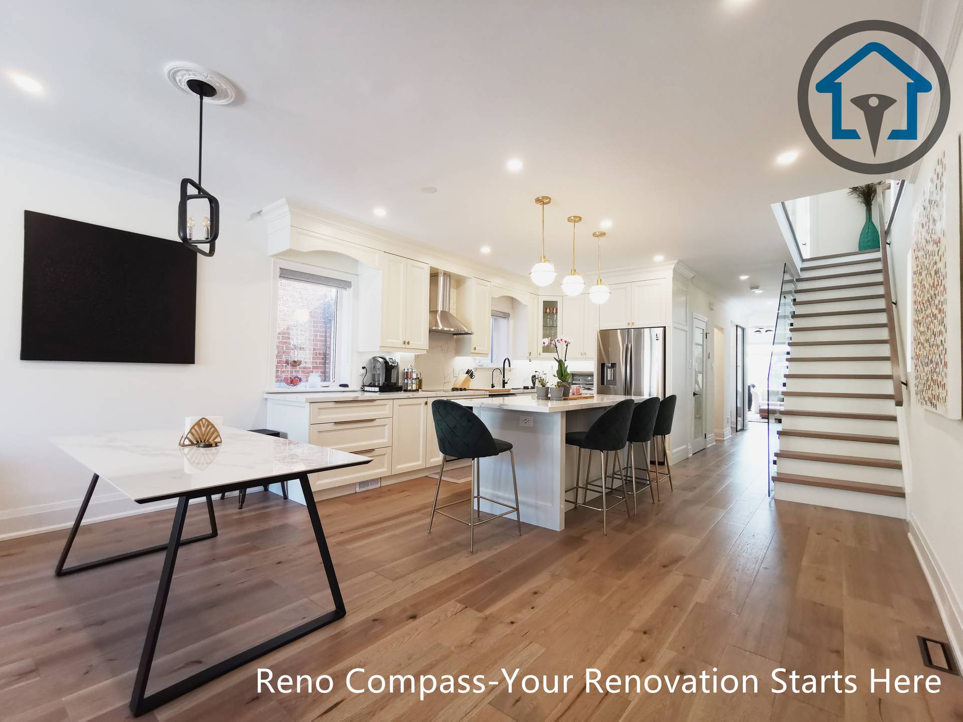 This image highlights the open-concept layout of a North York interior renovation, where the kitchen, dining area, and staircase are visually connected to create a spacious and cohesive living environment. A large central island with seating anchors the kitchen, complemented by custom white cabinetry, pendant lighting, and stainless steel appliances. Wide-plank hardwood flooring runs continuously throughout the space, enhancing flow and visual consistency. The adjacent dining area and modern staircase reinforce the home’s open layout and functional zoning. Completed by a Toronto renovation company, this project demonstrates balanced proportions, practical circulation, and a clean, modern interior design approach.