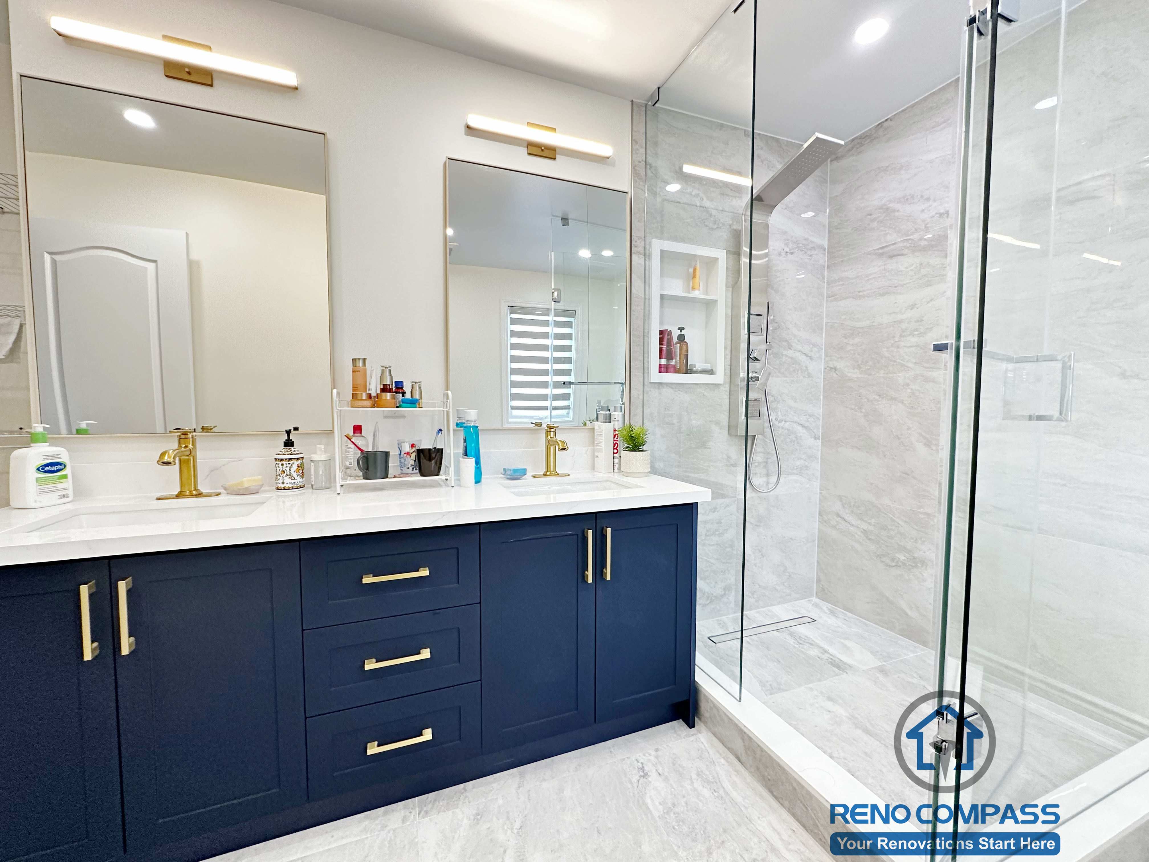 Master bathroom renovation in Markham featuring a frameless glass shower, large-format tile finishes, a custom vanity with matte black cabinetry, and brass fixtures. The design combines clean lines, efficient layout, and a refined modern aesthetic for everyday comfort.