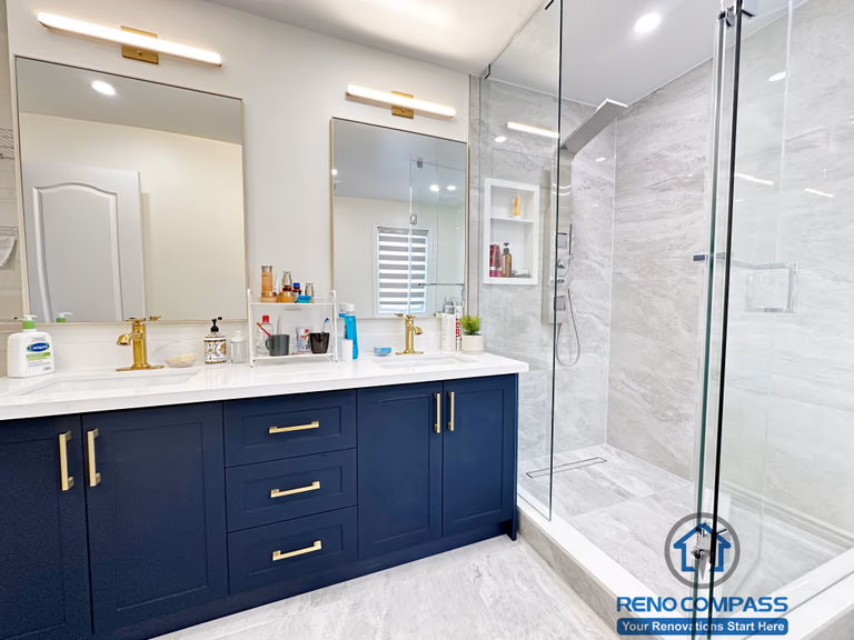Master bathroom renovation in Markham featuring a frameless glass shower, large-format tile finishes, a custom vanity with matte black cabinetry, and brass fixtures. The design combines clean lines, efficient layout, and a refined modern aesthetic for everyday comfort.