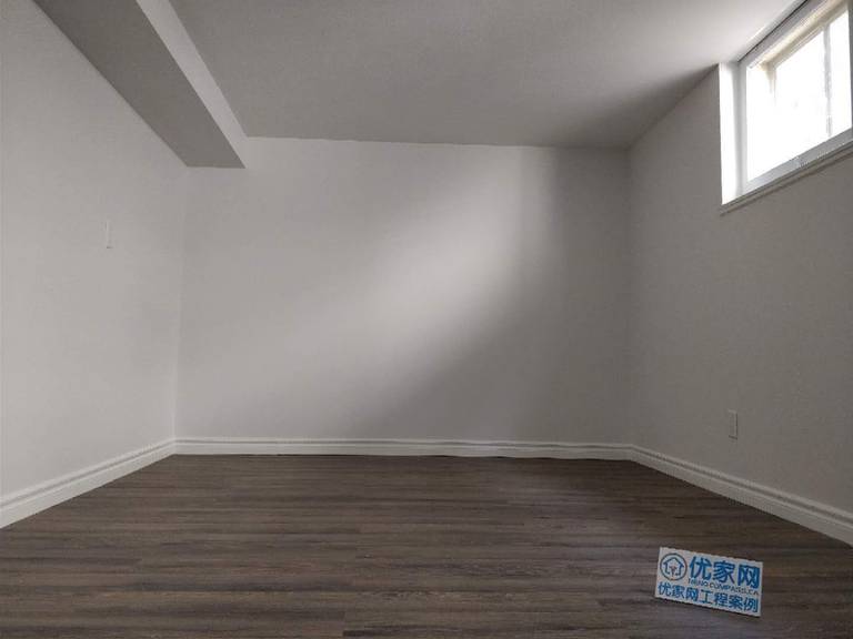 This Scarborough basement renovation features a clean and modern finished living space with durable vinyl flooring, smooth painted walls, and upgraded baseboards. A high basement window allows natural light to brighten the room, creating a comfortable and functional area suitable for a recreation room, home office, or additional living space. Completed with attention to detail, this basement upgrade improves both usability and property value for the homeowner.