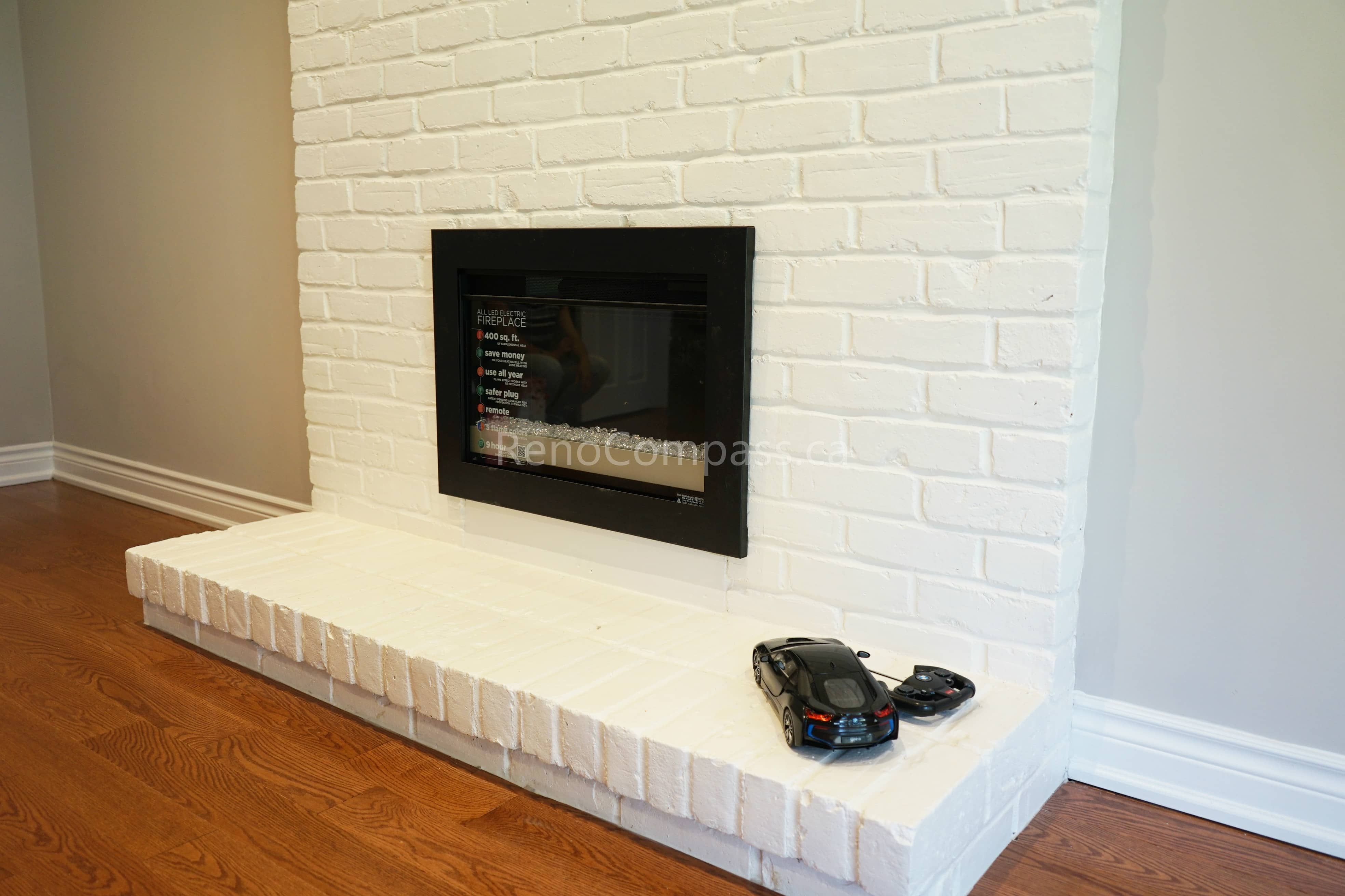 This North York interior renovation highlights a clean white brick fireplace feature wall with a modern built-in fireplace insert. The refreshed brick finish and minimalist hearth design create a warm focal point while complementing the surrounding hardwood flooring. Completed by a professional Toronto renovation company, this project demonstrates precise masonry work, careful detailing, and high-quality interior renovation craftsmanship for Toronto homes.