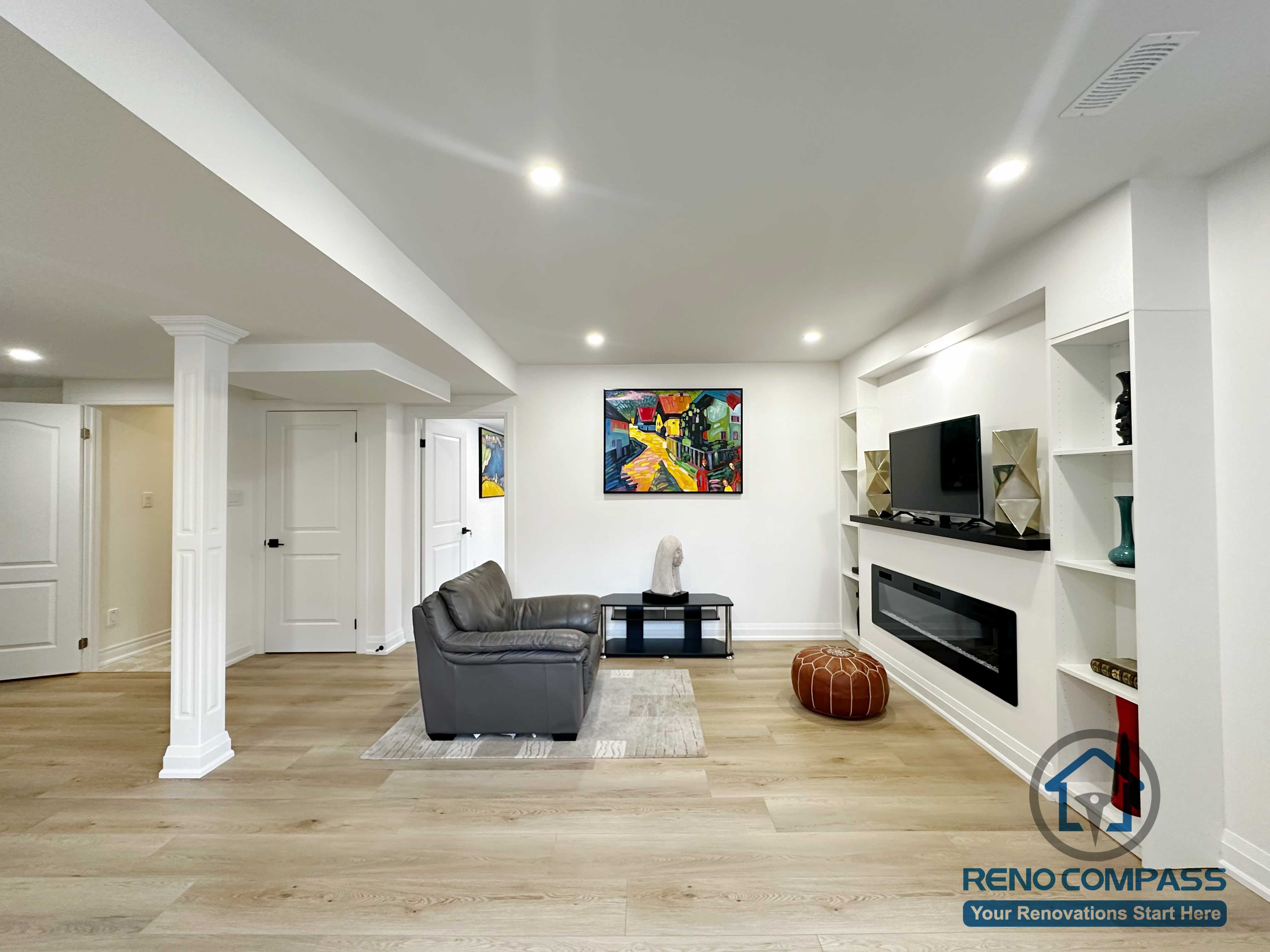 his open-concept basement living area in Richmond Hill was designed to maximize space, comfort, and natural flow. The renovation features wide-plank flooring, recessed ceiling lighting, and a custom built-in media wall with integrated shelving and a modern fireplace. Structural columns were thoughtfully incorporated into the layout to maintain openness while supporting the space. The result is a bright, functional basement living area ideal for everyday relaxation, entertaining guests, or family gatherings.