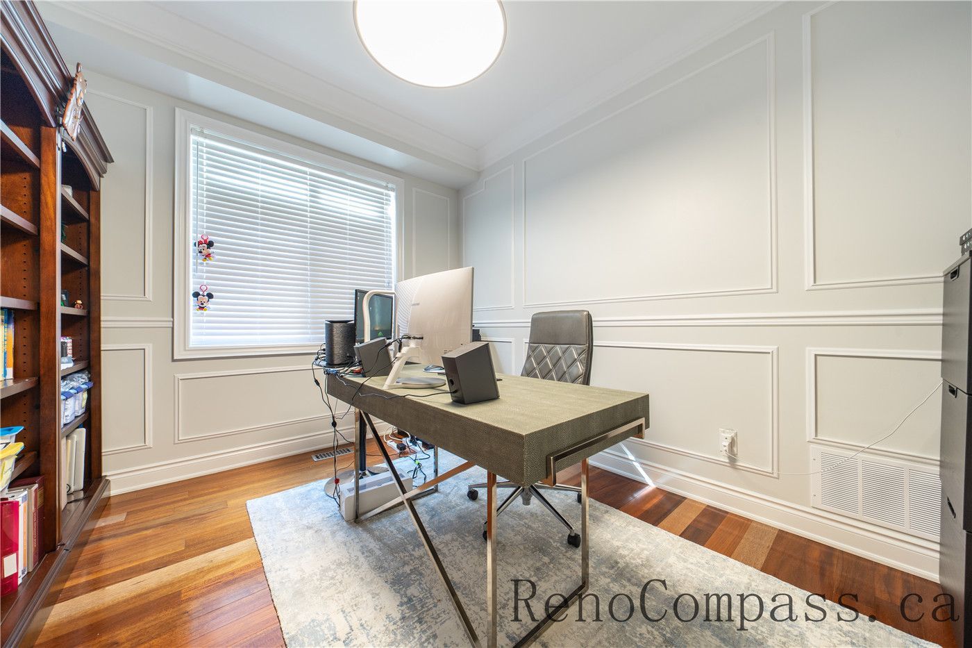 This Richmond Hill entire house interior renovation includes a modern home office designed with custom wall paneling, warm hardwood flooring, and a bright window layout for natural light. The clean and functional workspace enhances productivity while maintaining a timeless and elegant interior style. Completed by a professional Toronto renovation company, this home office renovation combines comfort, organization, and refined craftsmanship for everyday use.