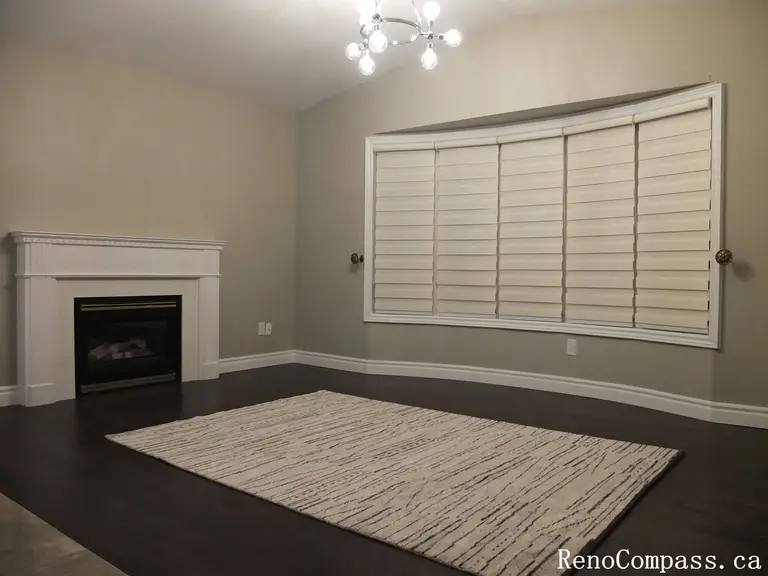 This Richmond Hill curtains installation project highlights custom window blinds installed in a spacious living room with modern finishes and hardwood flooring. The neutral-toned blinds complement the fireplace feature wall and contemporary lighting, providing excellent light control, privacy, and a cohesive interior look. Professionally measured and installed, these custom window coverings enhance comfort and style while matching the home’s elegant renovation design. Ideal for homeowners in Richmond Hill and the Greater Toronto Area seeking high-quality curtain and blinds installation for living spaces.